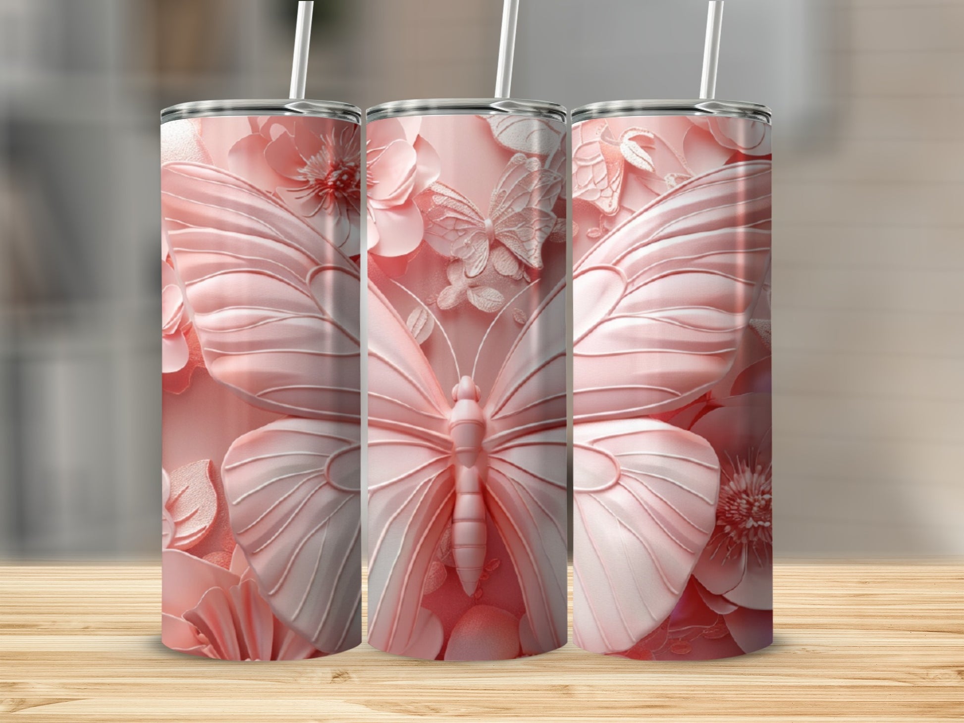 Three pink tumblers featuring embossed butterflies and floral designs.