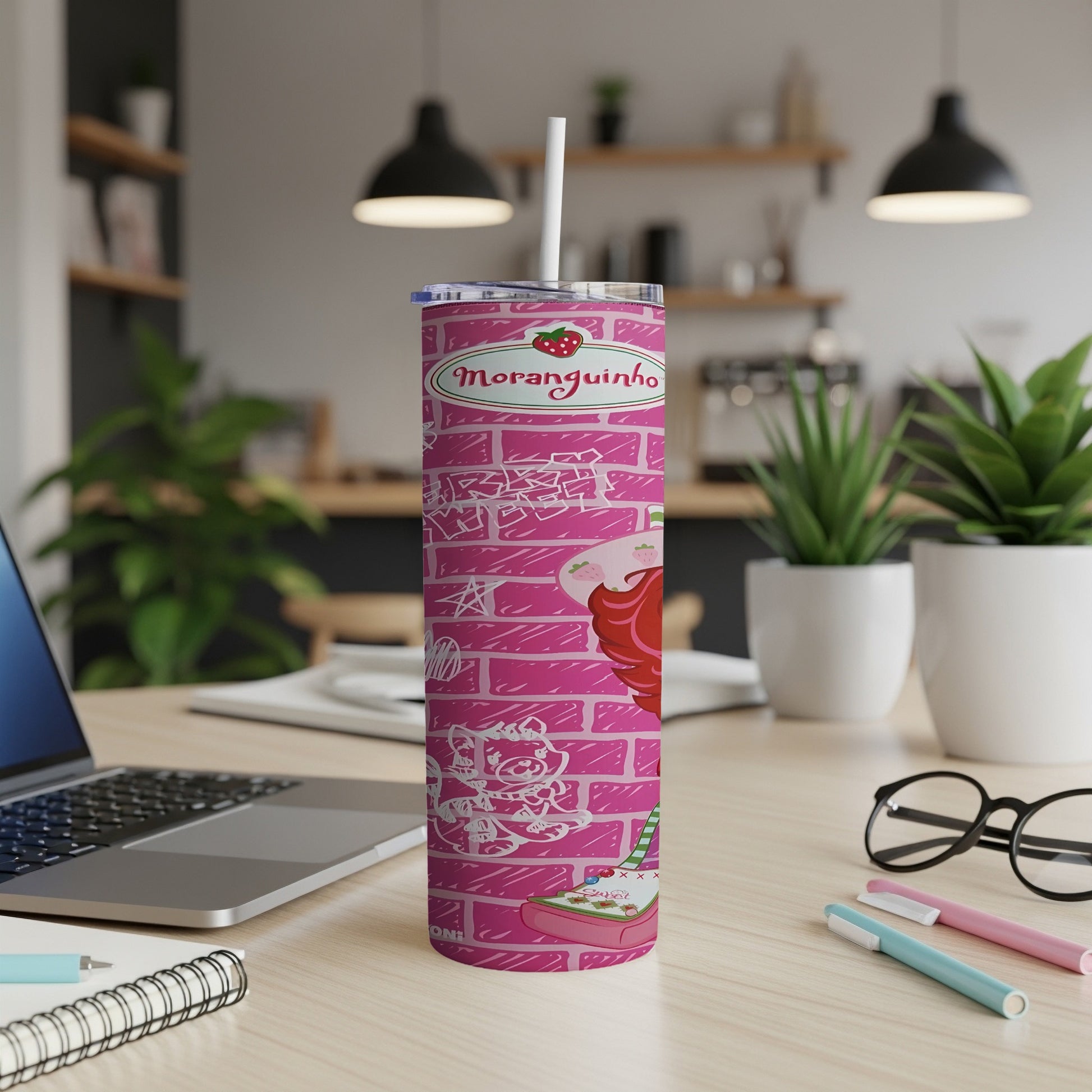 Pink tumbler with Moranguinho character and brick pattern.