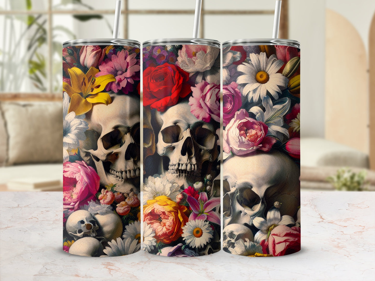 Three tumblers with skulls and floral designs in bright colors.