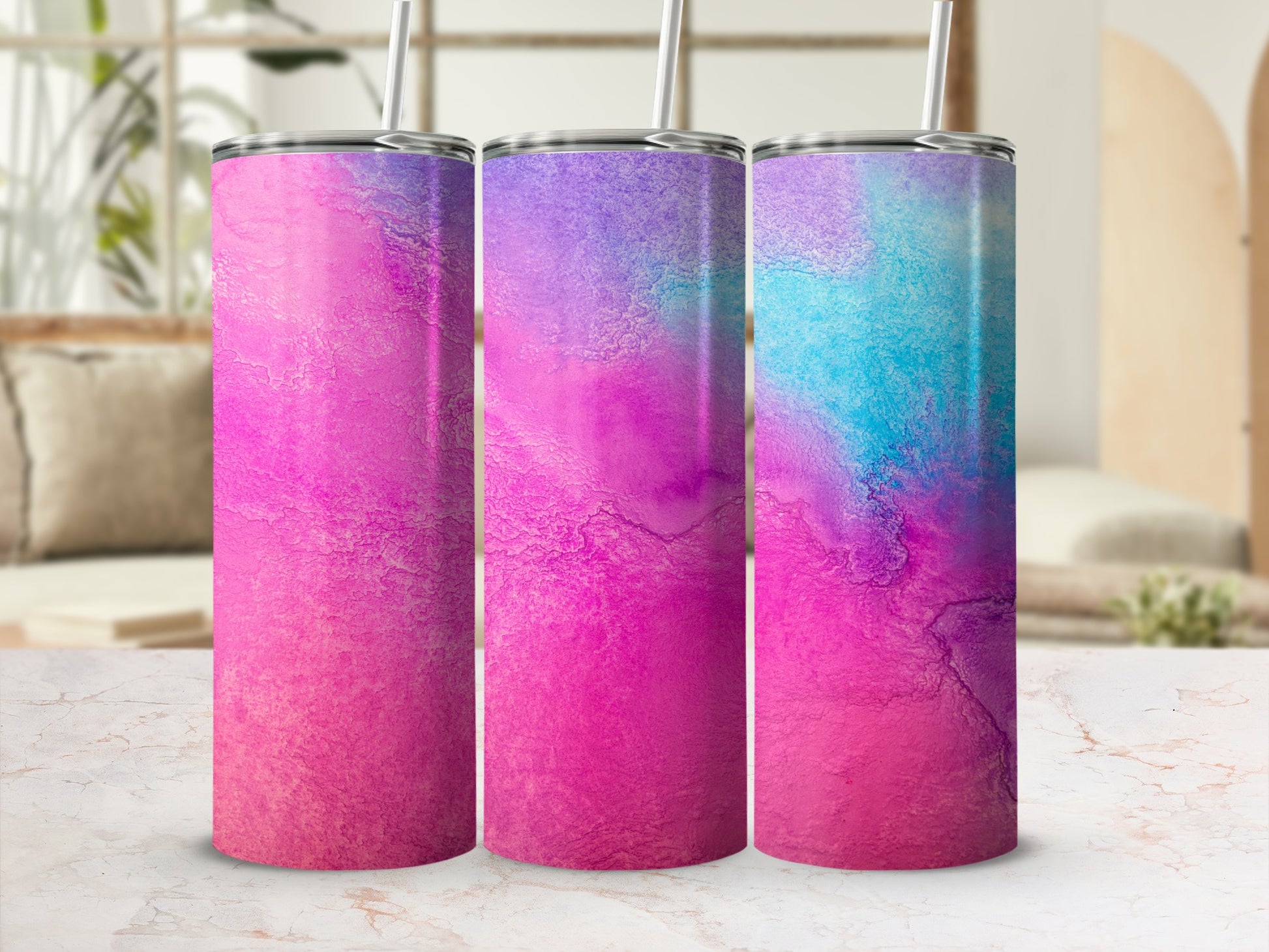 Three tumblers with a marbled pink, purple, and blue watercolor design.