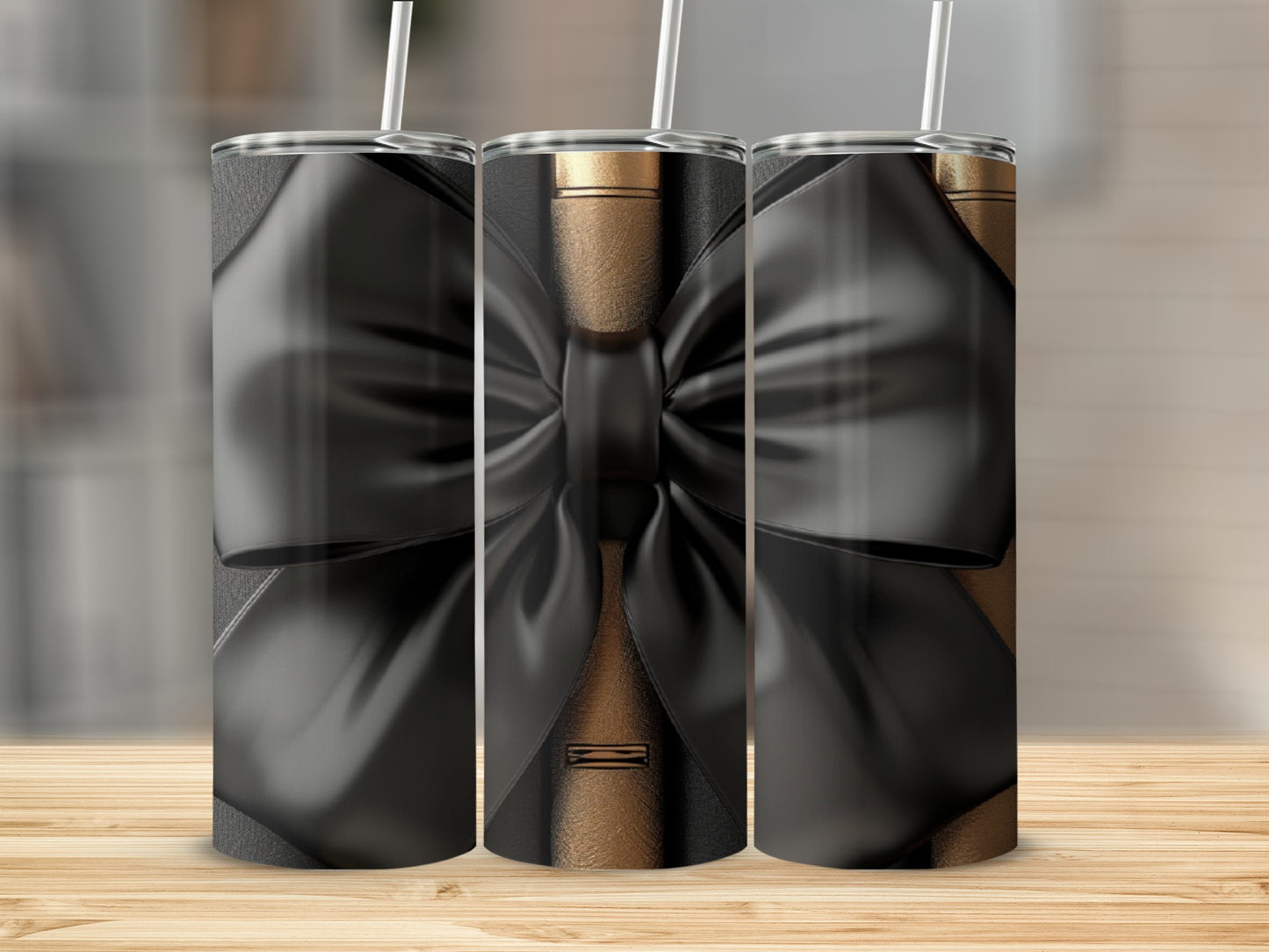 Three tumblers with black bows on a wood background.