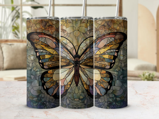 Three tumblers with a stained glass butterfly design on a marbled countertop.