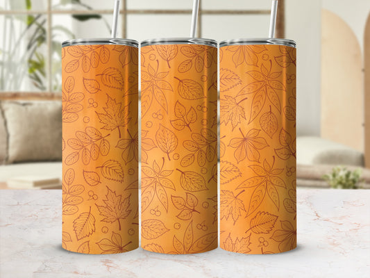 Three orange tumblers with a repeating leaf pattern and straws.