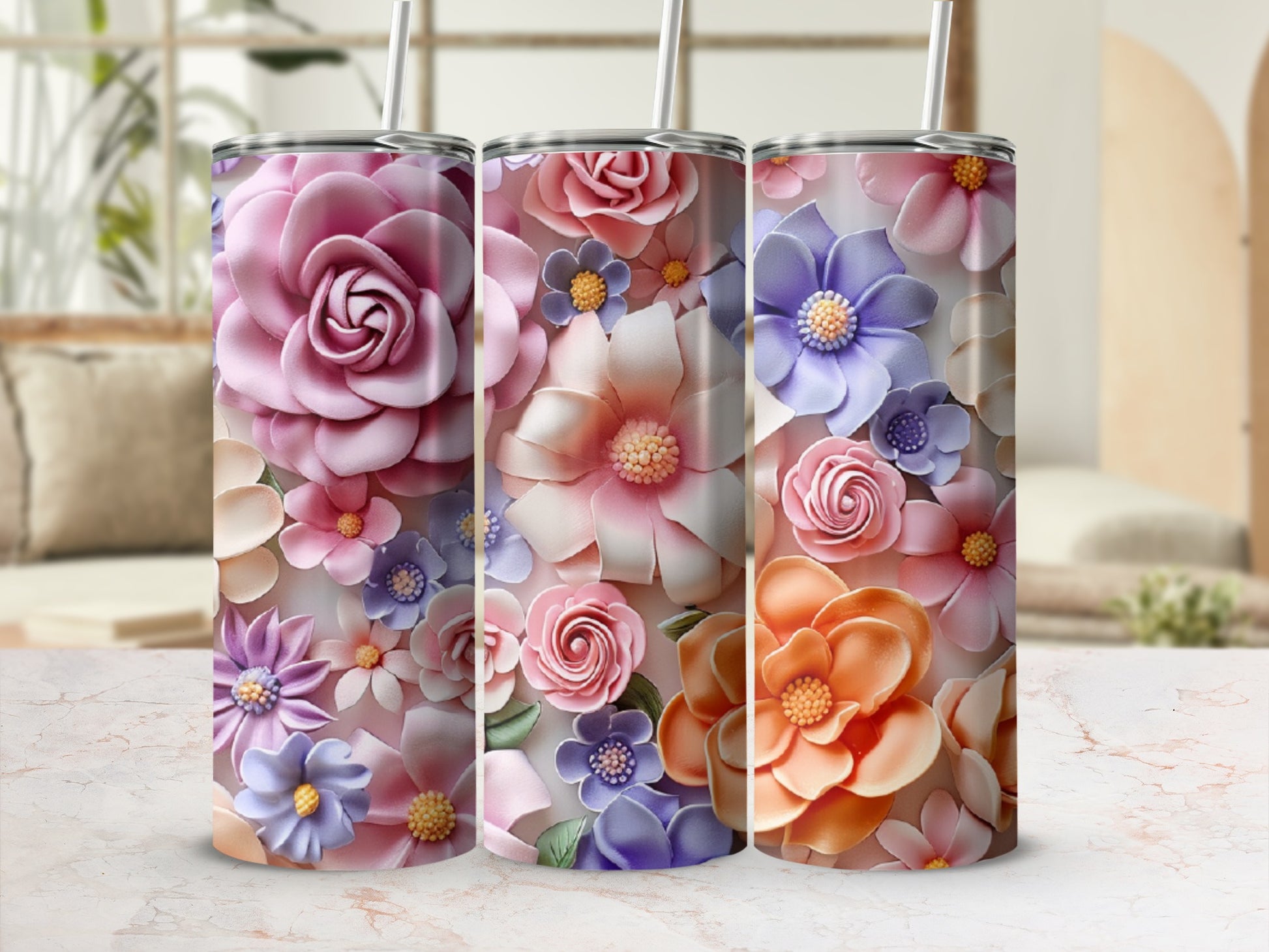 Three tumblers with floral designs in pastel colors.