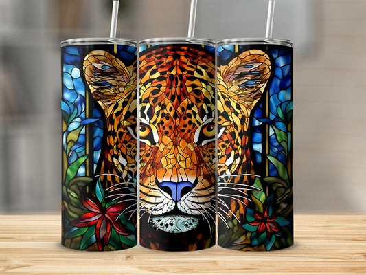 Stained glass leopard face with blue and red flowers and green leaves.