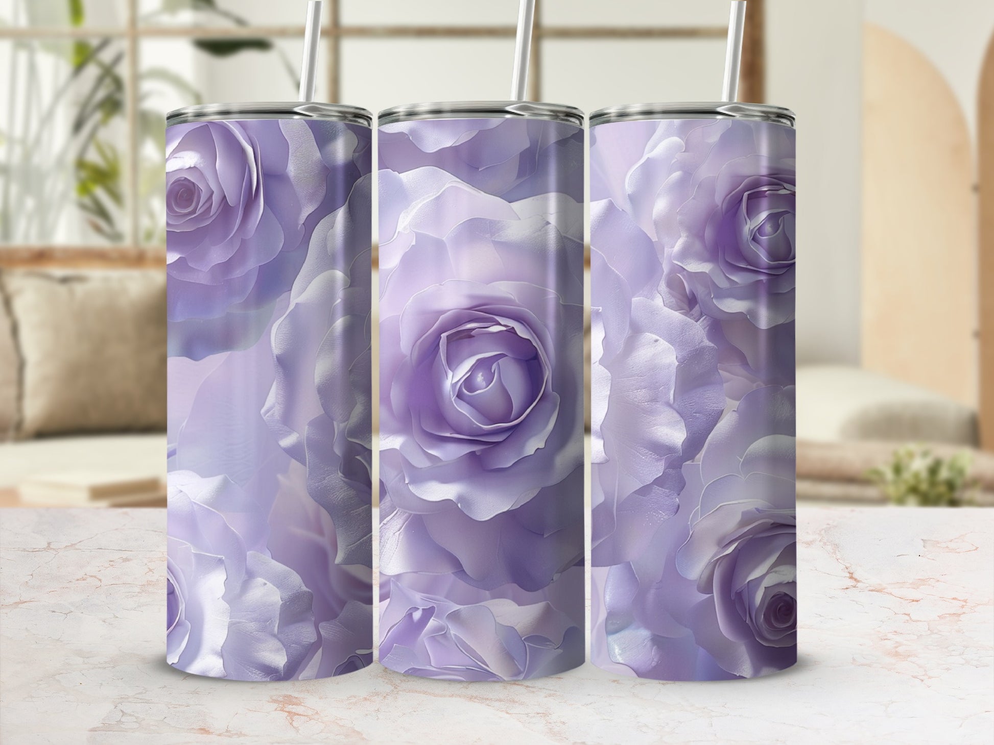 Three purple rose-patterned tumblers with straws on a marble surface.