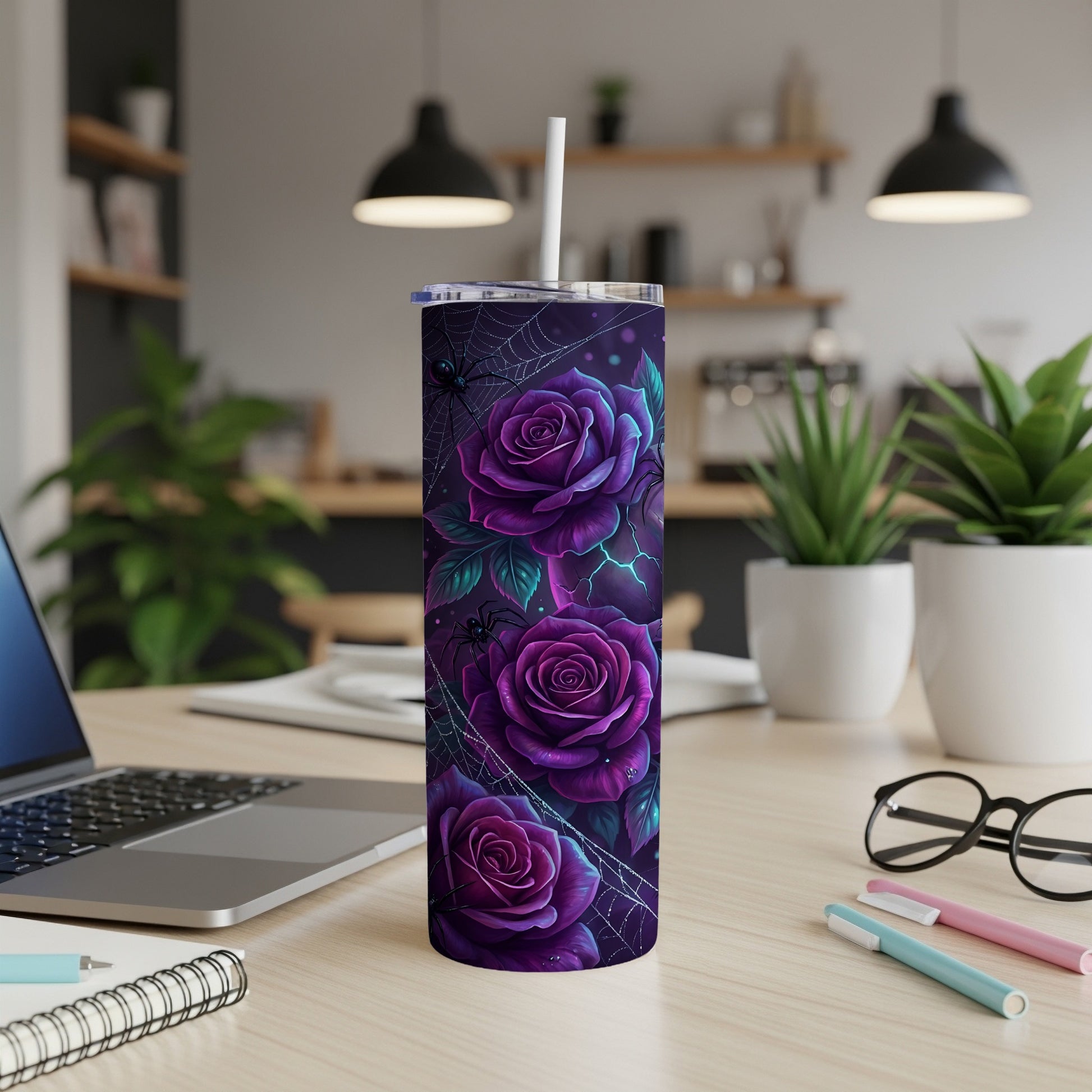 Purple roses and spiderwebs pattern on a tall tumbler with a straw.