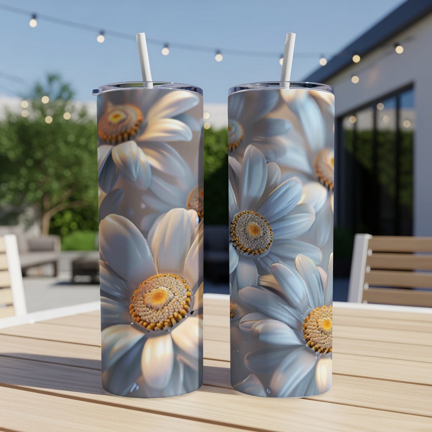 Two white daisies on a patterned tumbler, with a blurred outdoor background.