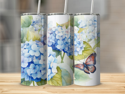 White tumbler with watercolor blue hydrangeas and a butterfly.