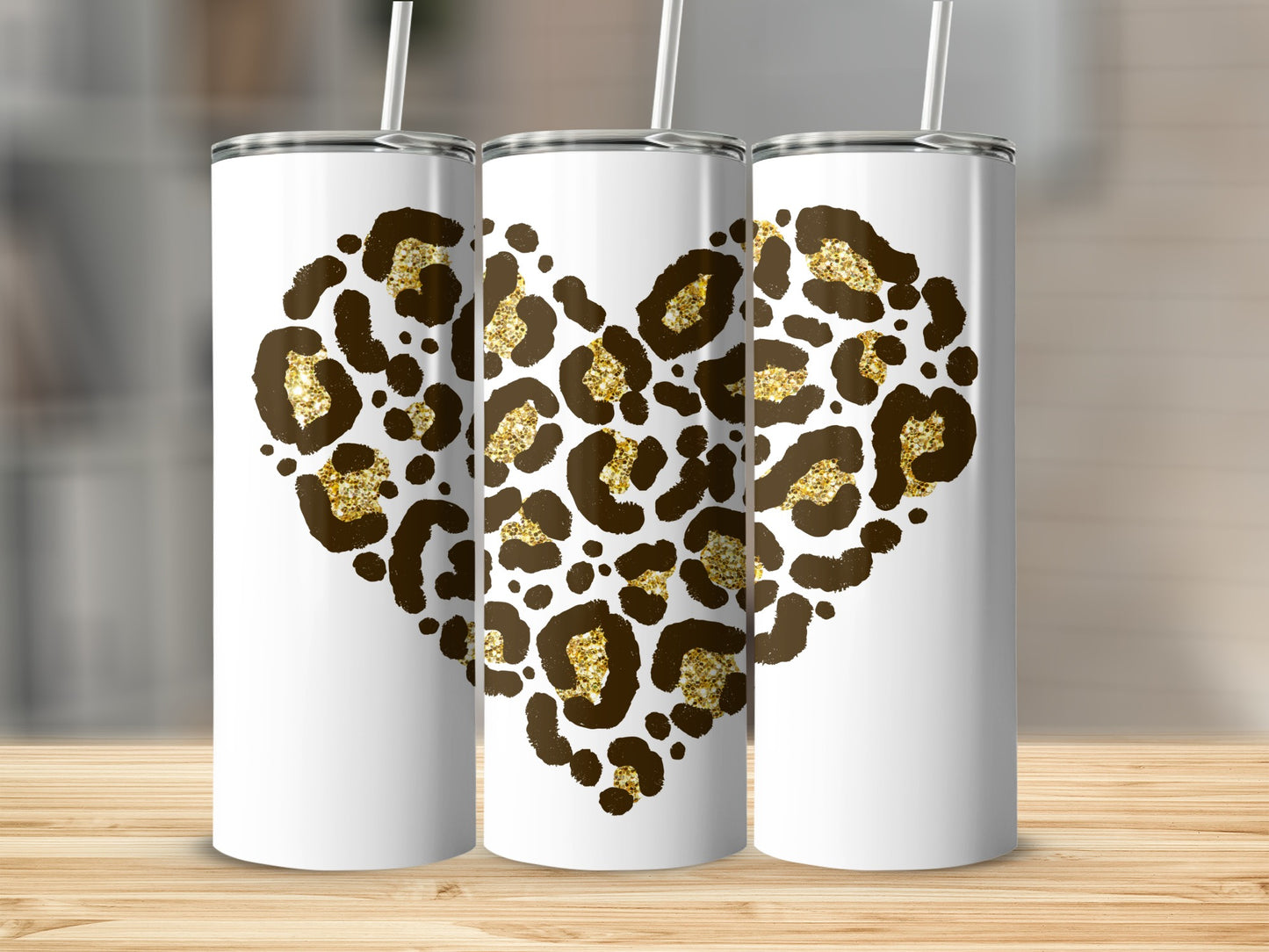 Three white tumblers with leopard print hearts and gold glitter accents.