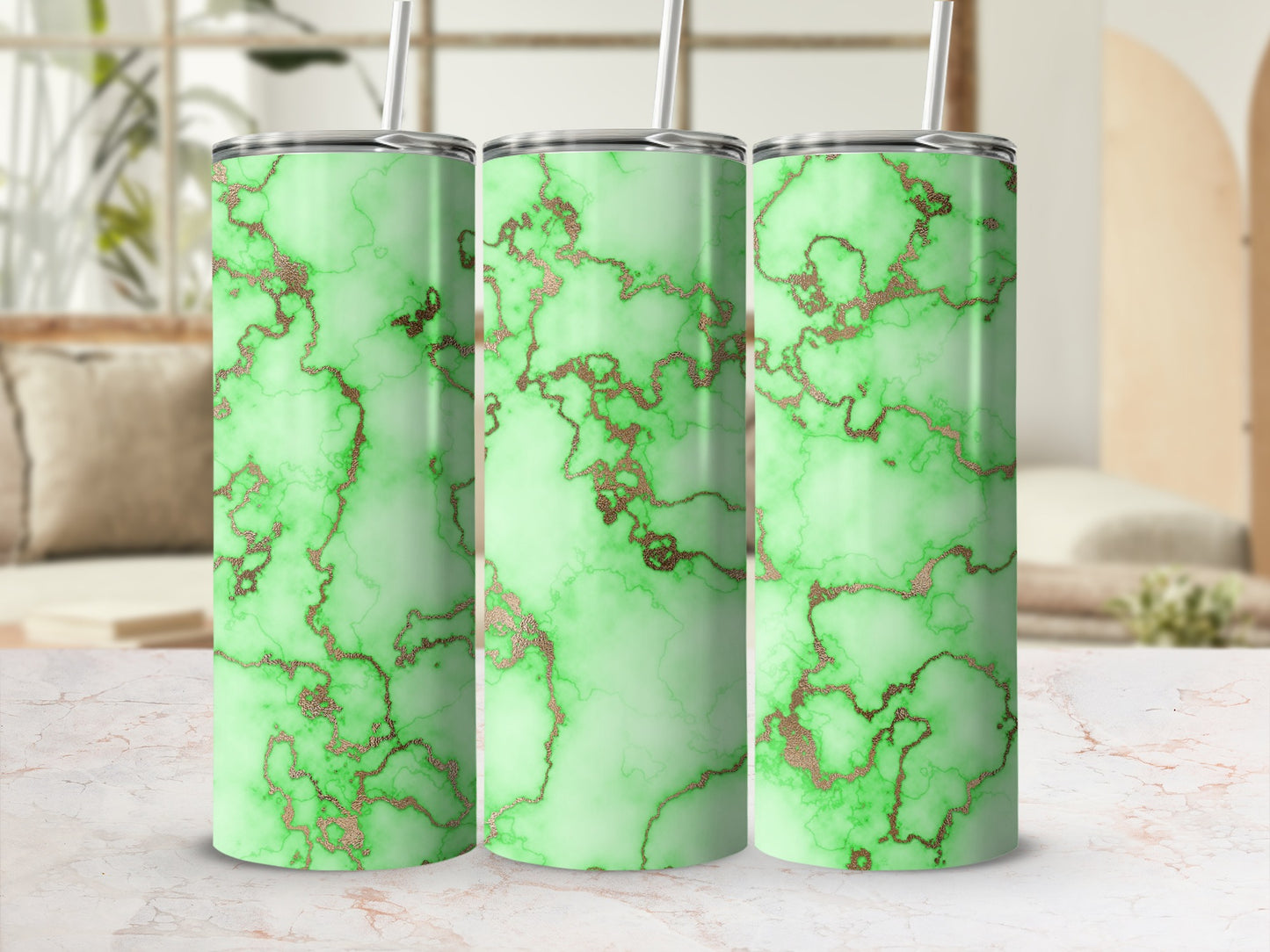 Three green marble tumblers with rose gold veining and straws.