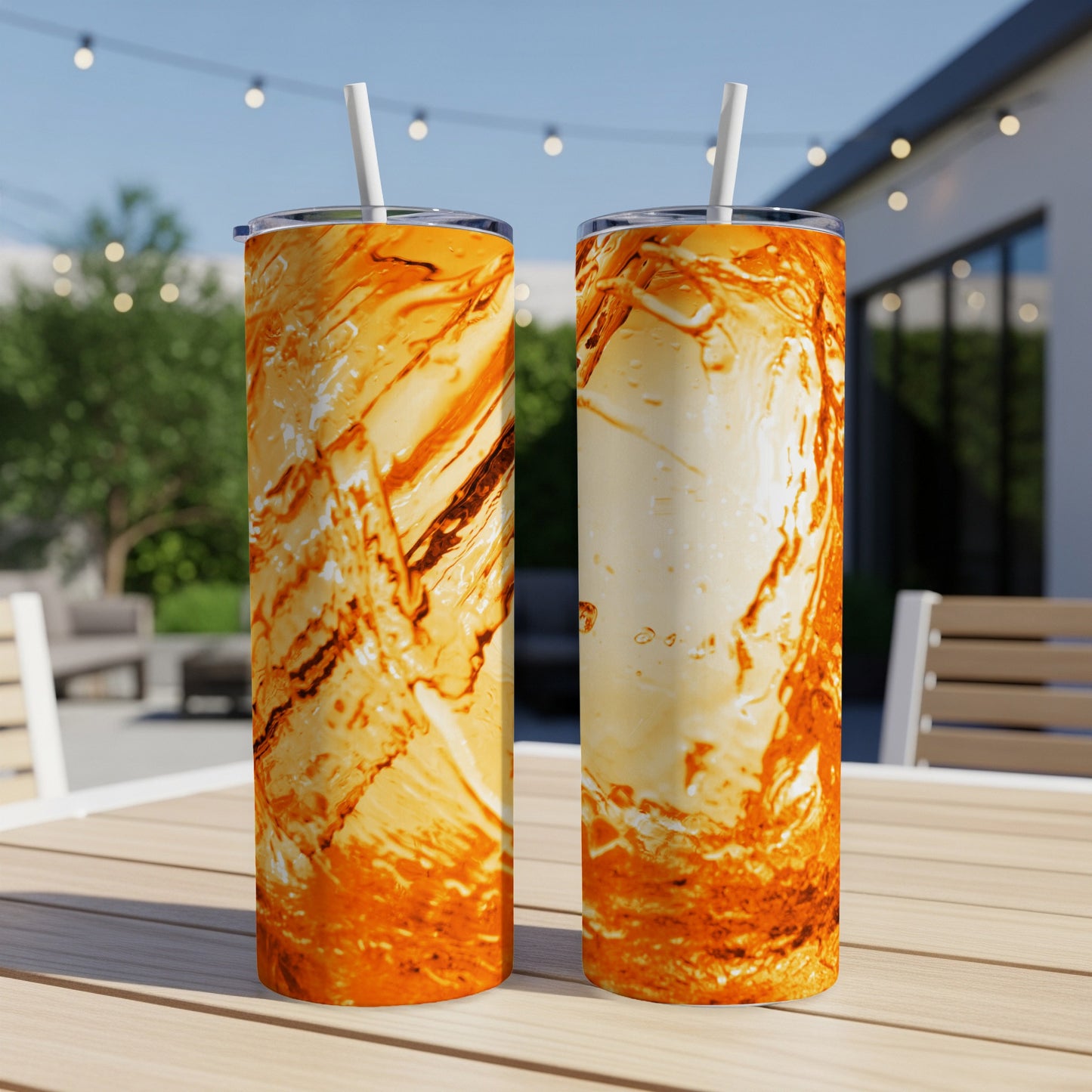 Two tumblers with swirling orange and brown marbled design on a table.