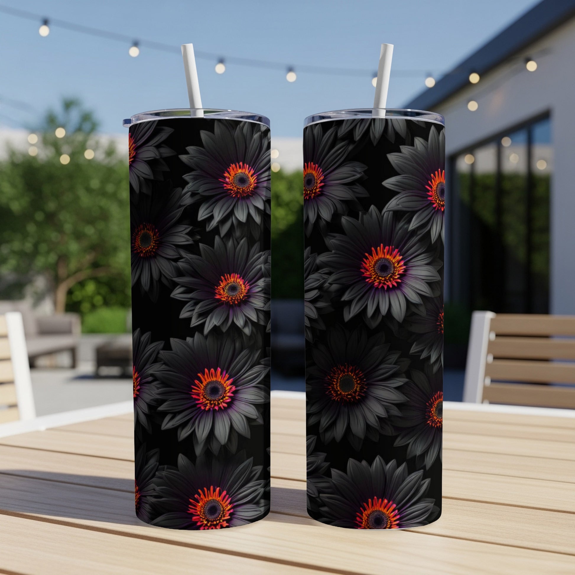 Two tumblers with black daisy floral patterns and orange centers.
