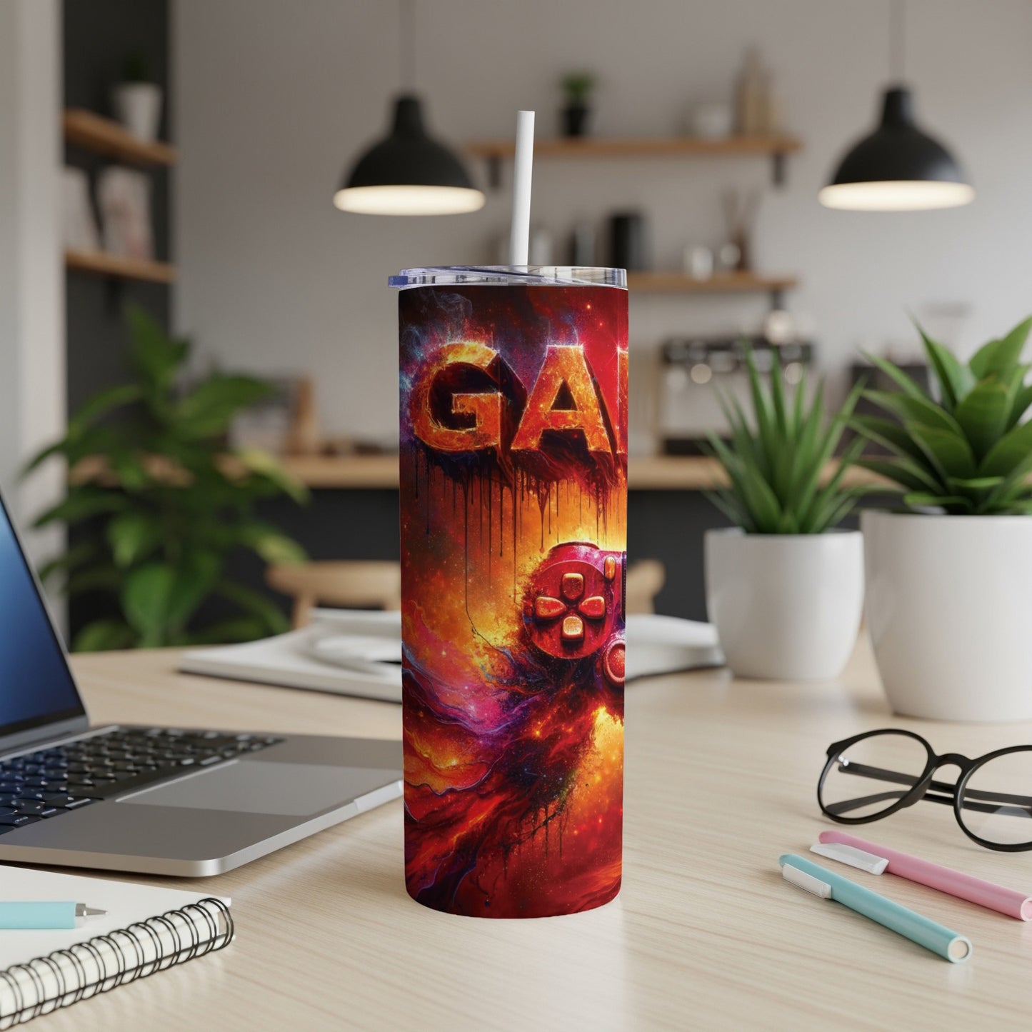 Red and orange galaxy design on a gaming tumbler with a controller.