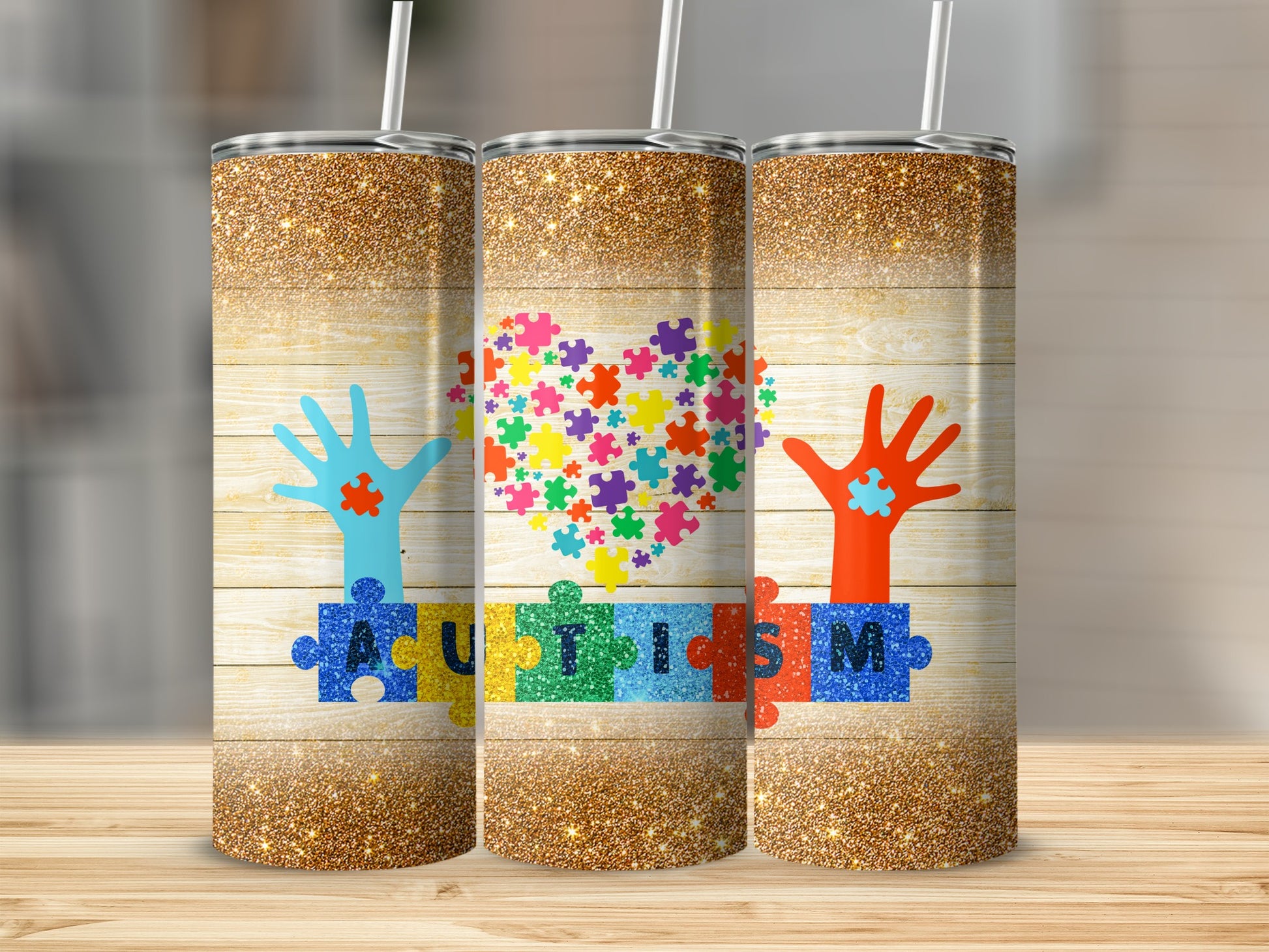 Three tumblers with a wooden background, autism puzzle pieces, and hands.
