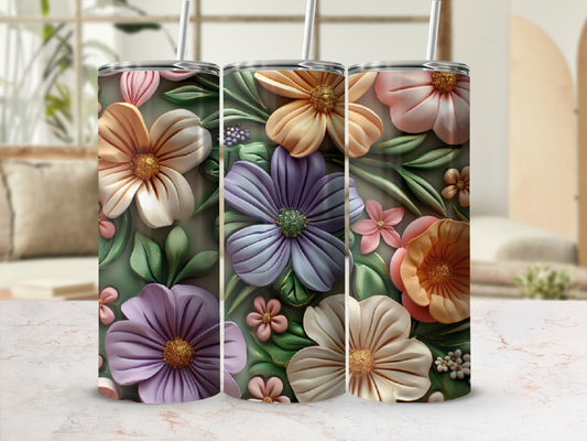 Three tall tumblers with colorful floral designs and straws.