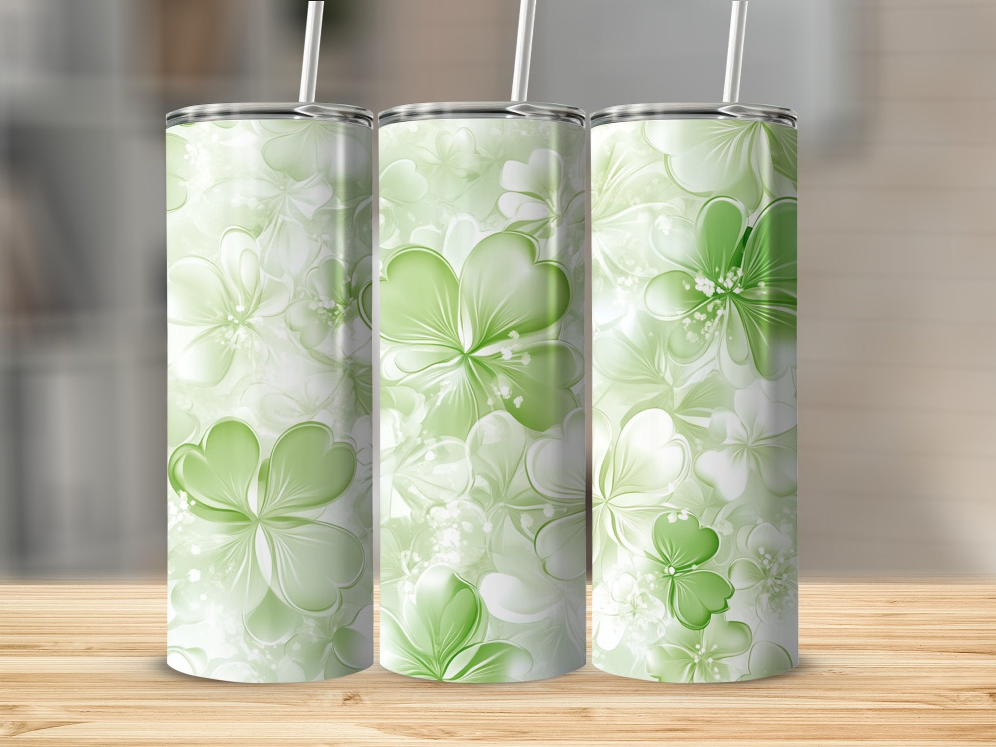 Three tumblers with a light green shamrock and floral pattern.