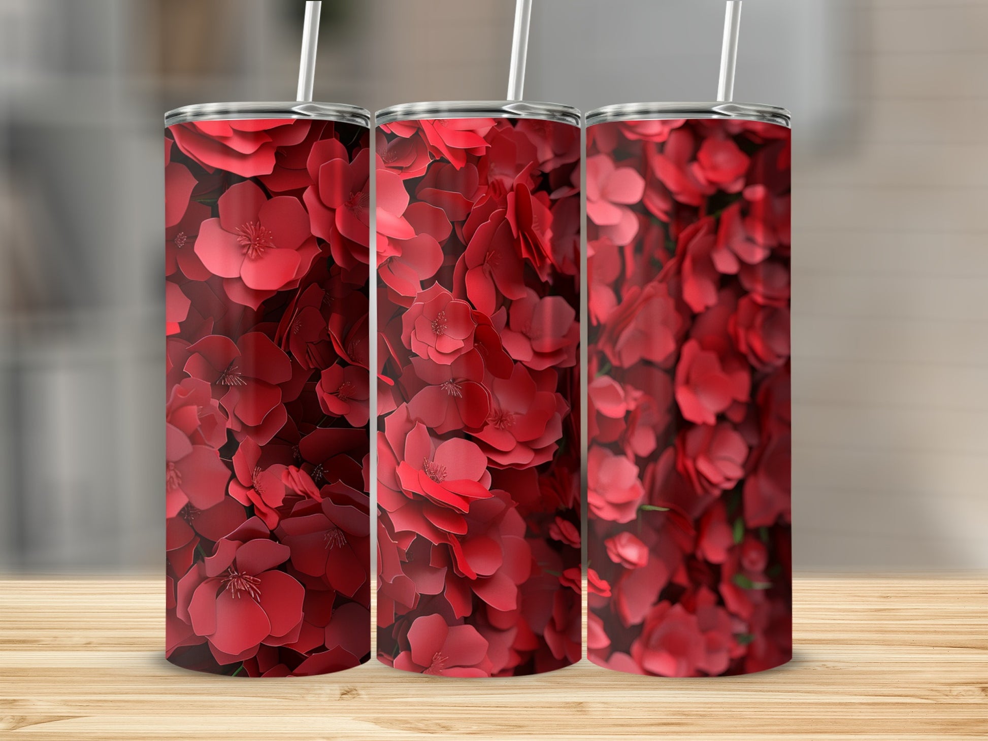 Three tumblers with a repeating pattern of vibrant red floral blossoms.