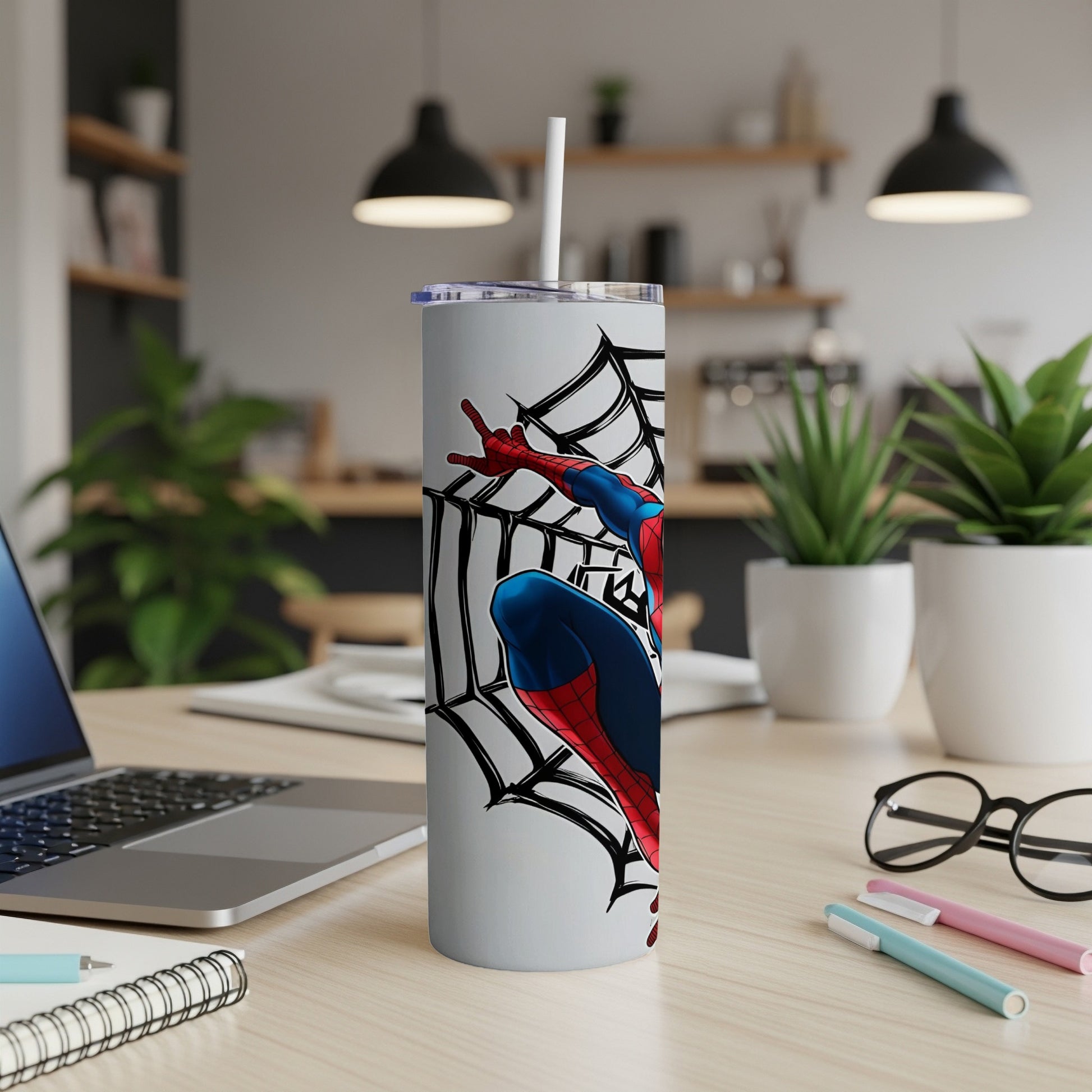 Spider-Man striking a pose on a white tumbler with a black web design.