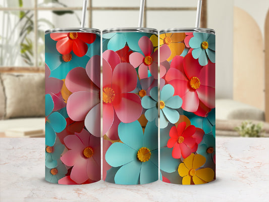 Three tumblers with colorful floral patterns in a blurred background.
