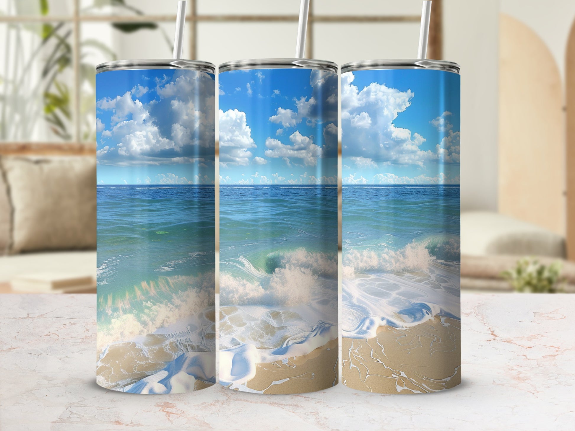 Three tumblers with ocean wave and beach scene design.