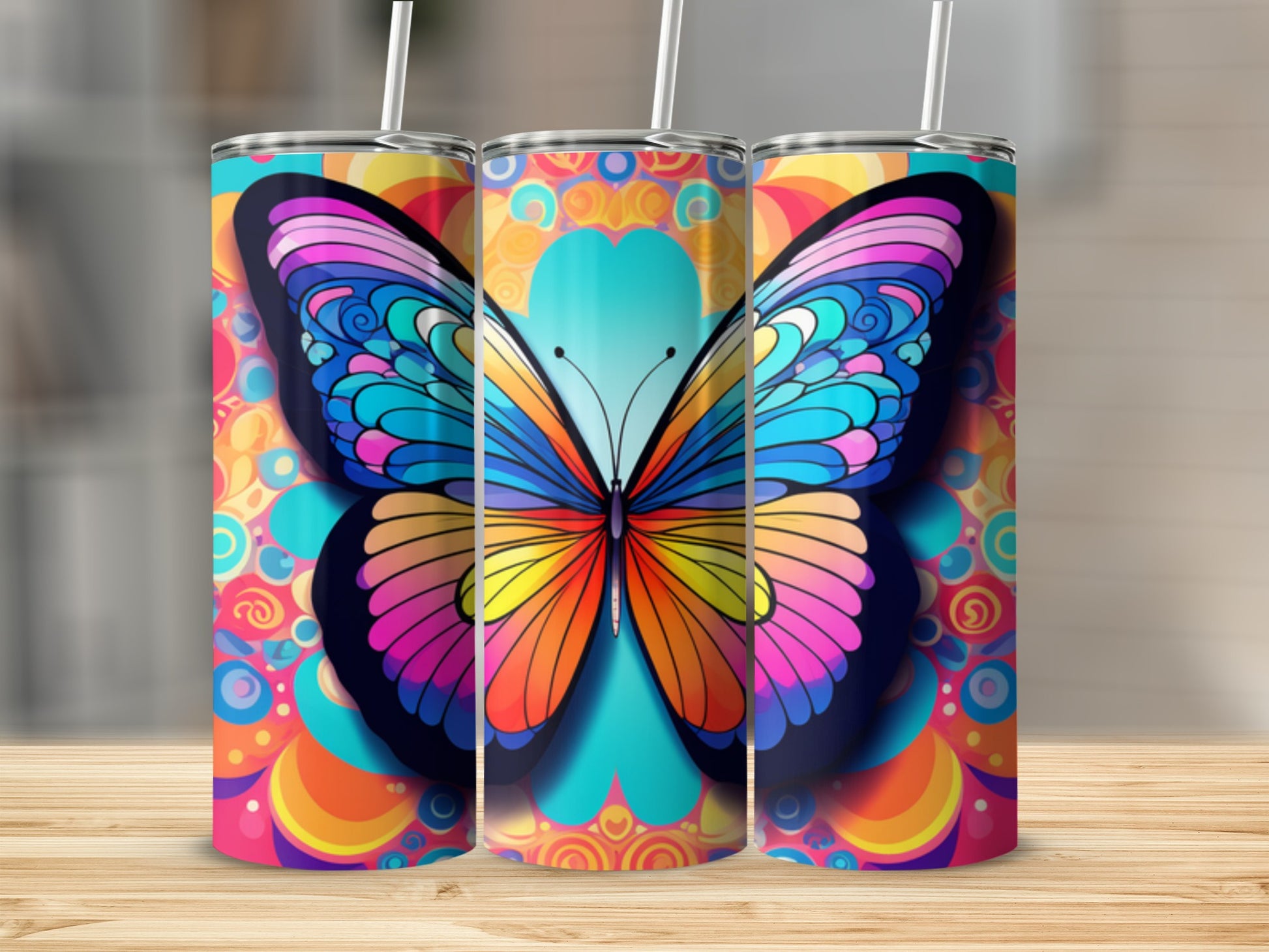 Three tumblers with colorful butterfly and psychedelic patterns.