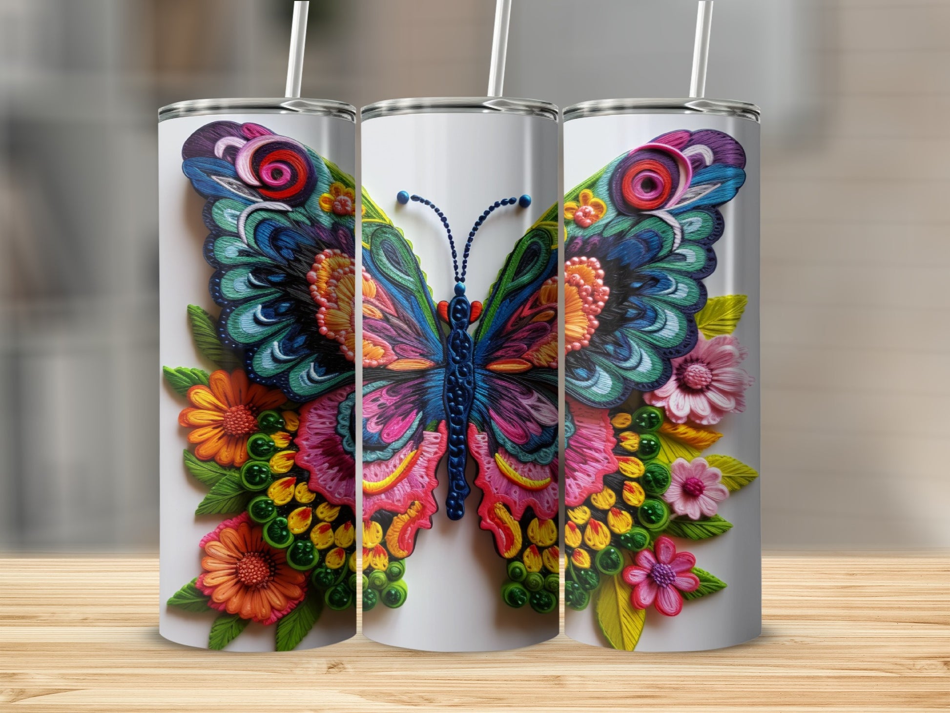 Three tumblers featuring a colorful, detailed butterfly with floral accents.