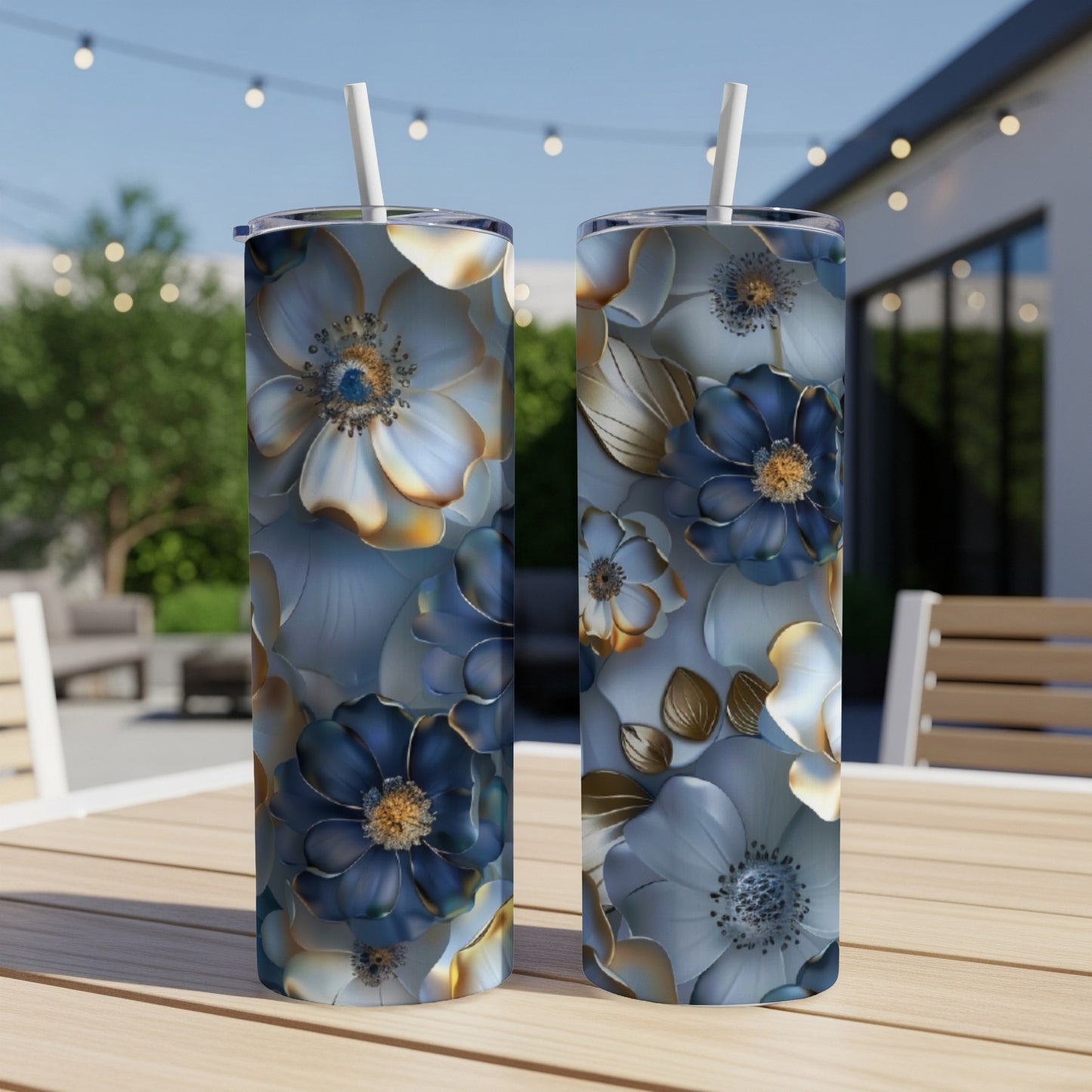 Two tumblers with blue and gold floral design sit on a wooden table.