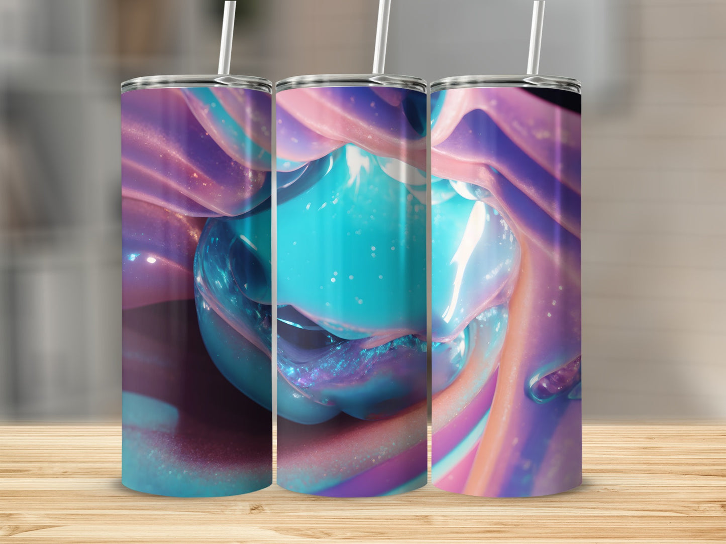 Three tumblers with colorful, swirling abstract patterns and straws.