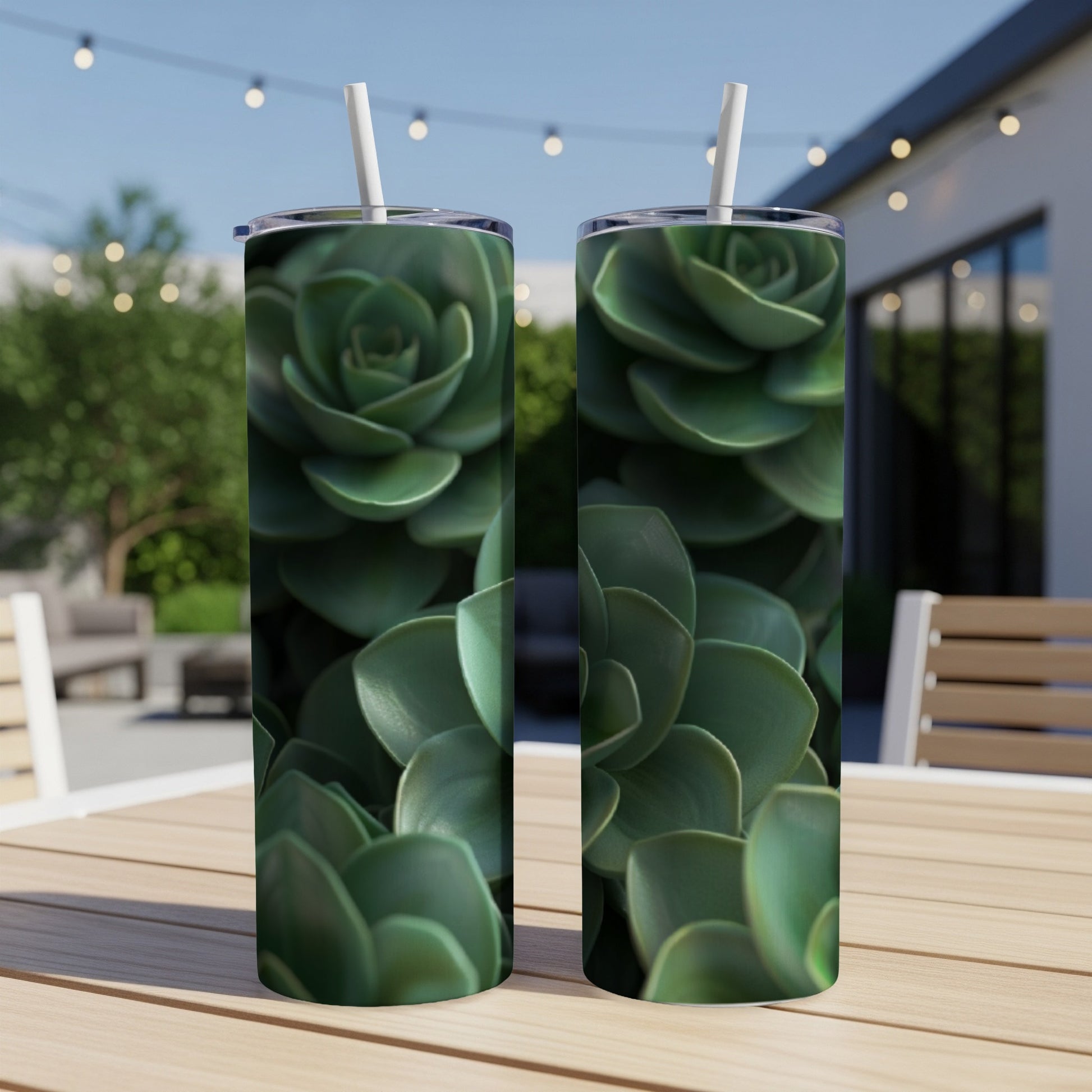 Two tumblers with close-up succulent plant designs sit on a wooden table.