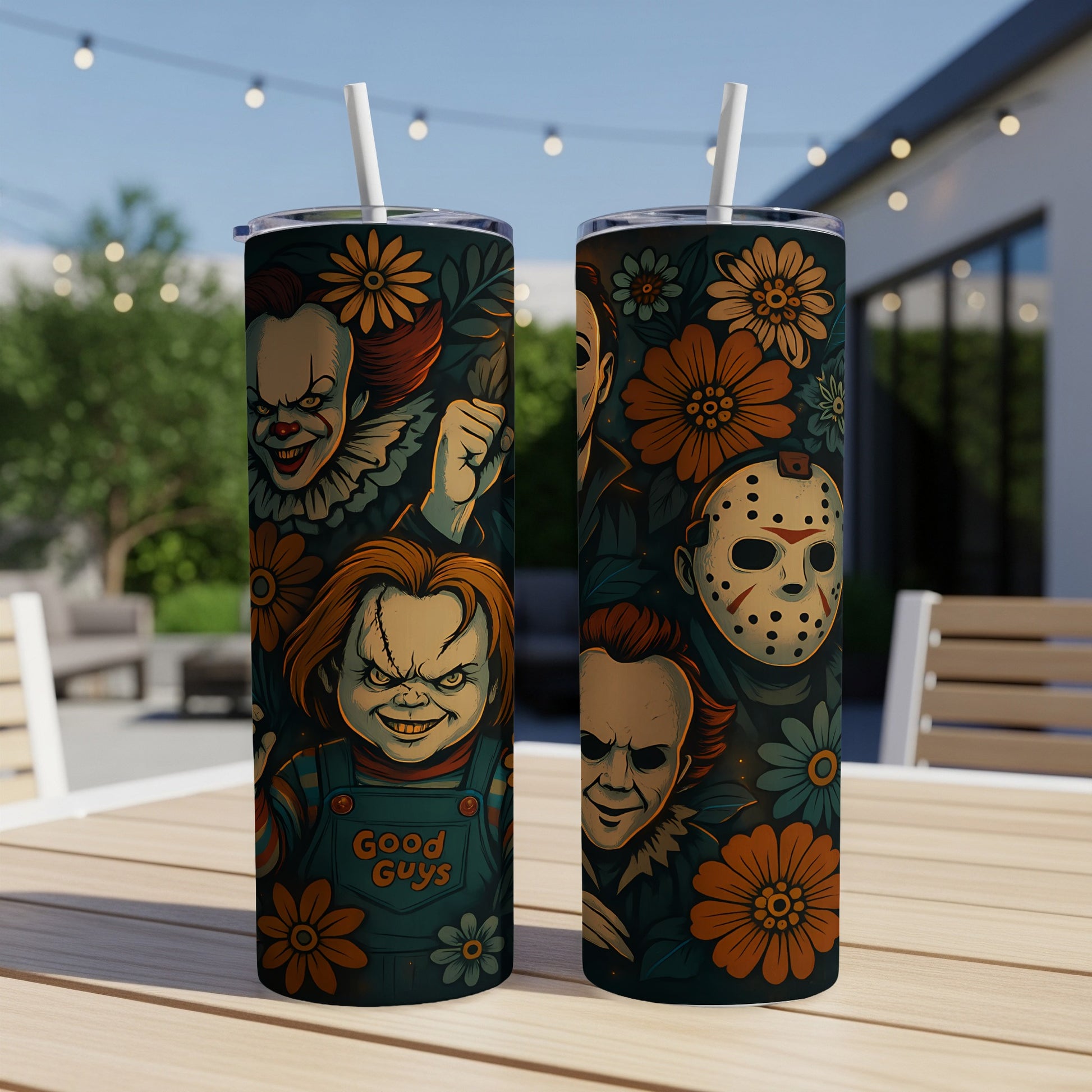 Two tumblers featuring horror characters and floral patterns on a table outdoors.