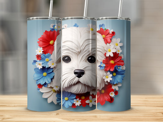 Maltese dog portrait surrounded by red, white, and blue flowers on a blue tumbler.