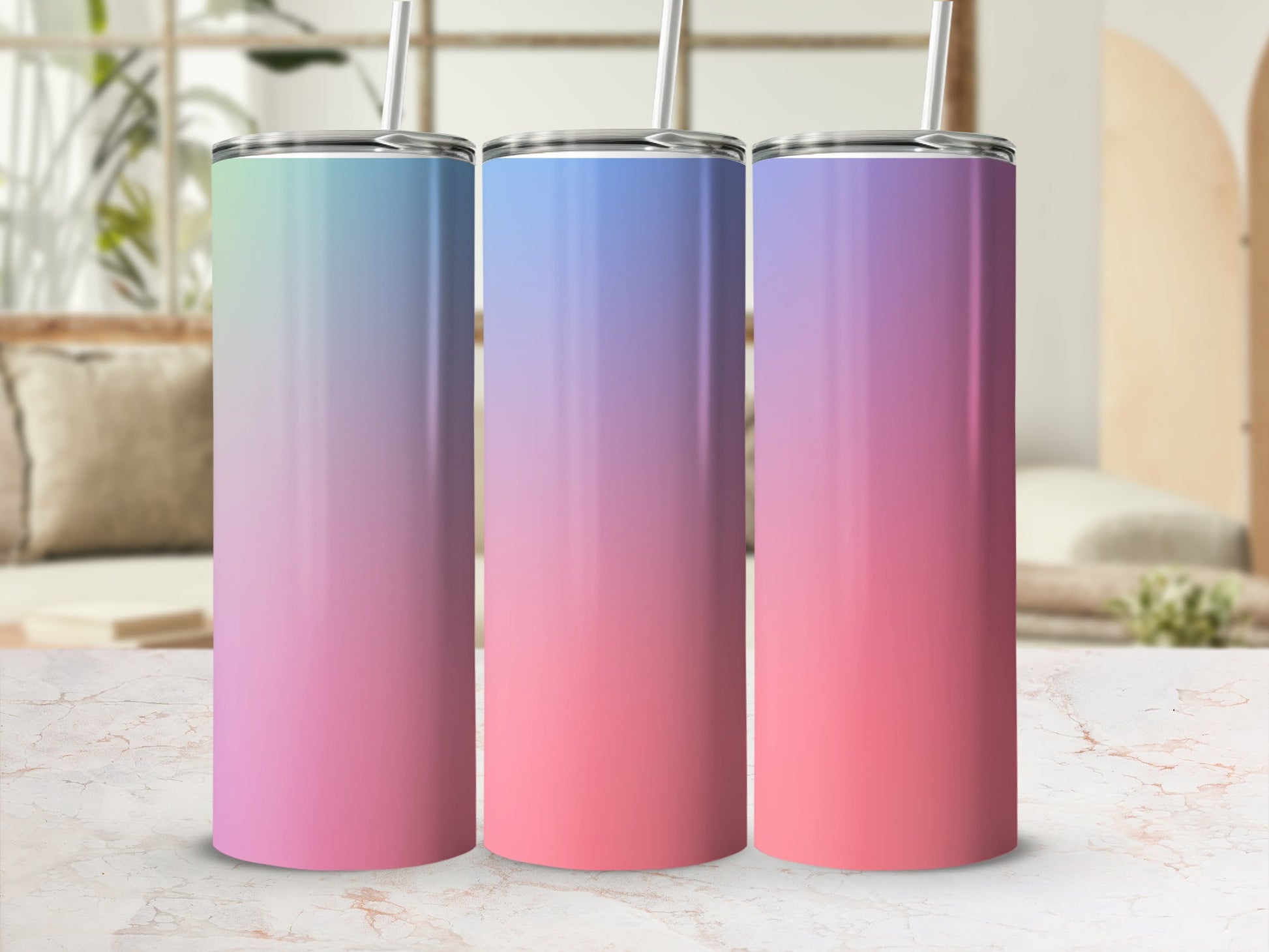 Three tumblers with a pastel gradient from green to pink, each with a silver lid and straw.