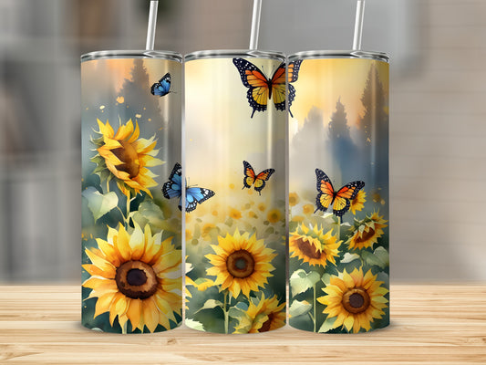 Three tumblers with sunflowers and butterflies against a blurred yellow and green background.