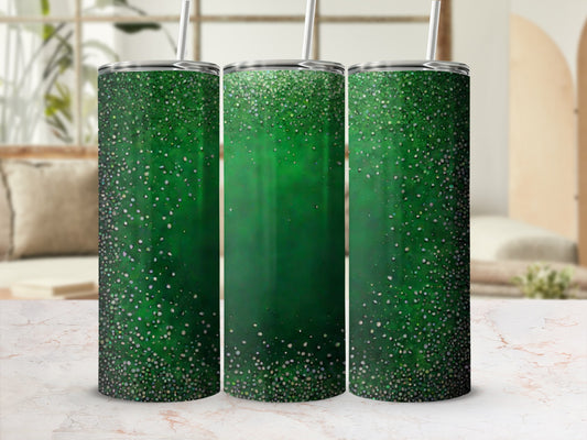 Three green glitter tumblers with reusable straws on a marbled surface.