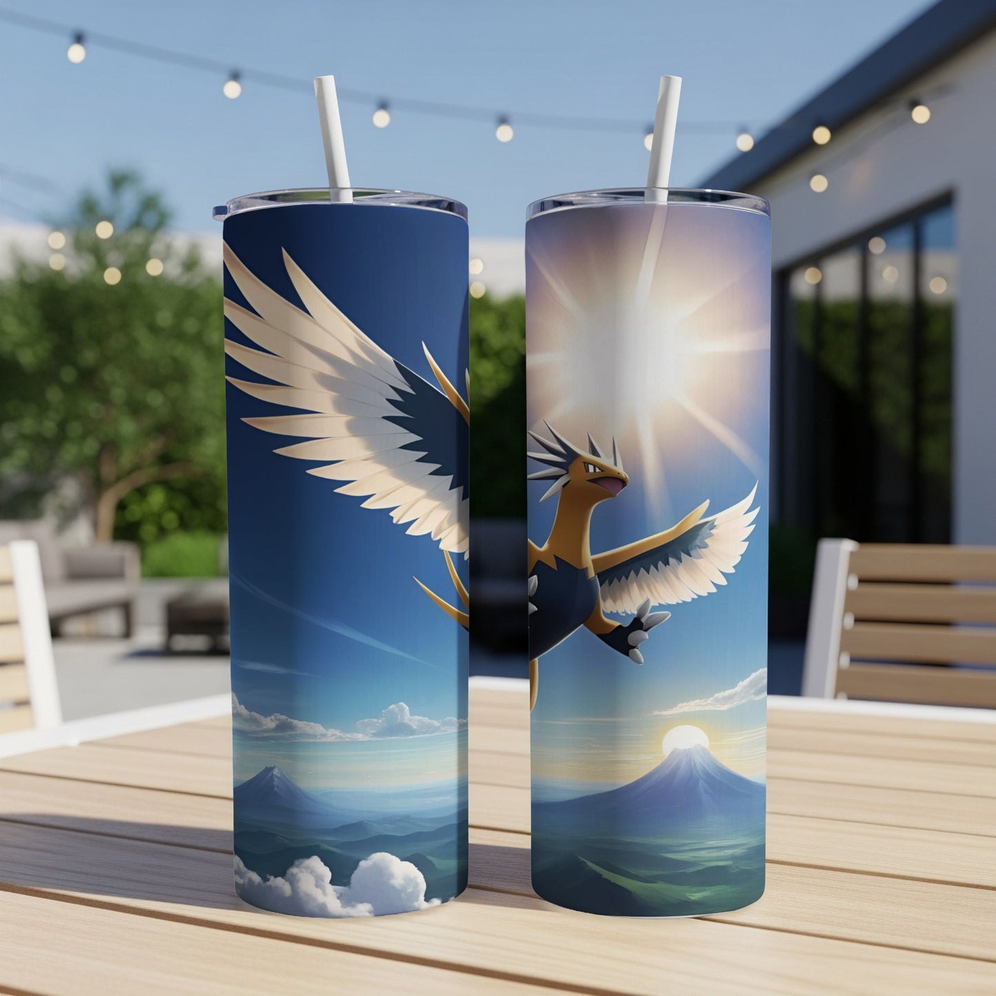 Two tumblers feature a fiery Pokémon soaring near a mountain and sun.