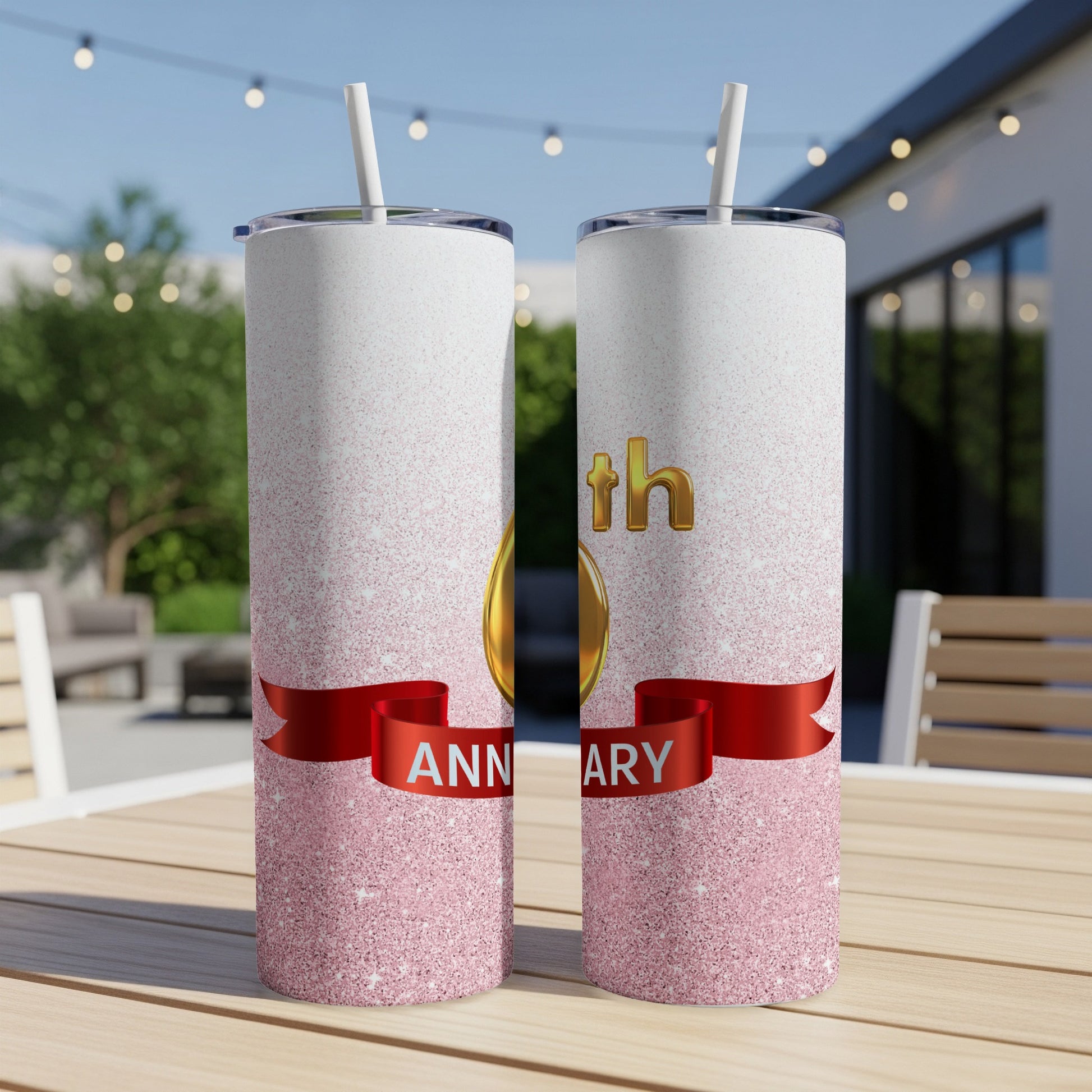 Gold "anniversary" text on a pink glitter tumbler with a red ribbon.