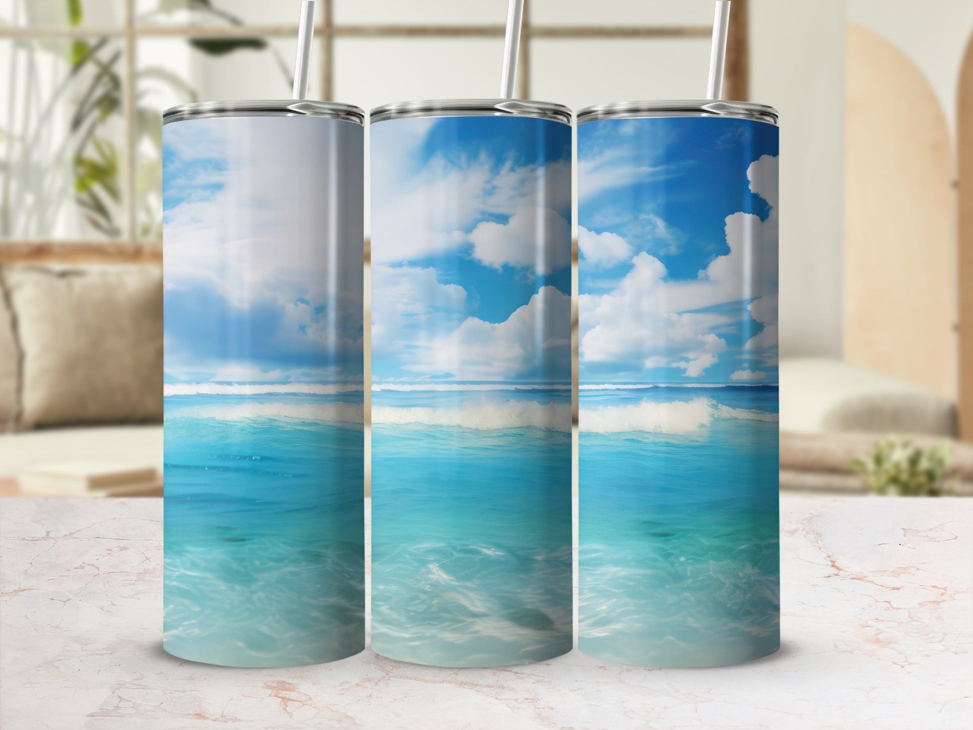 Three tumblers featuring ocean waves and a blue sky with clouds.