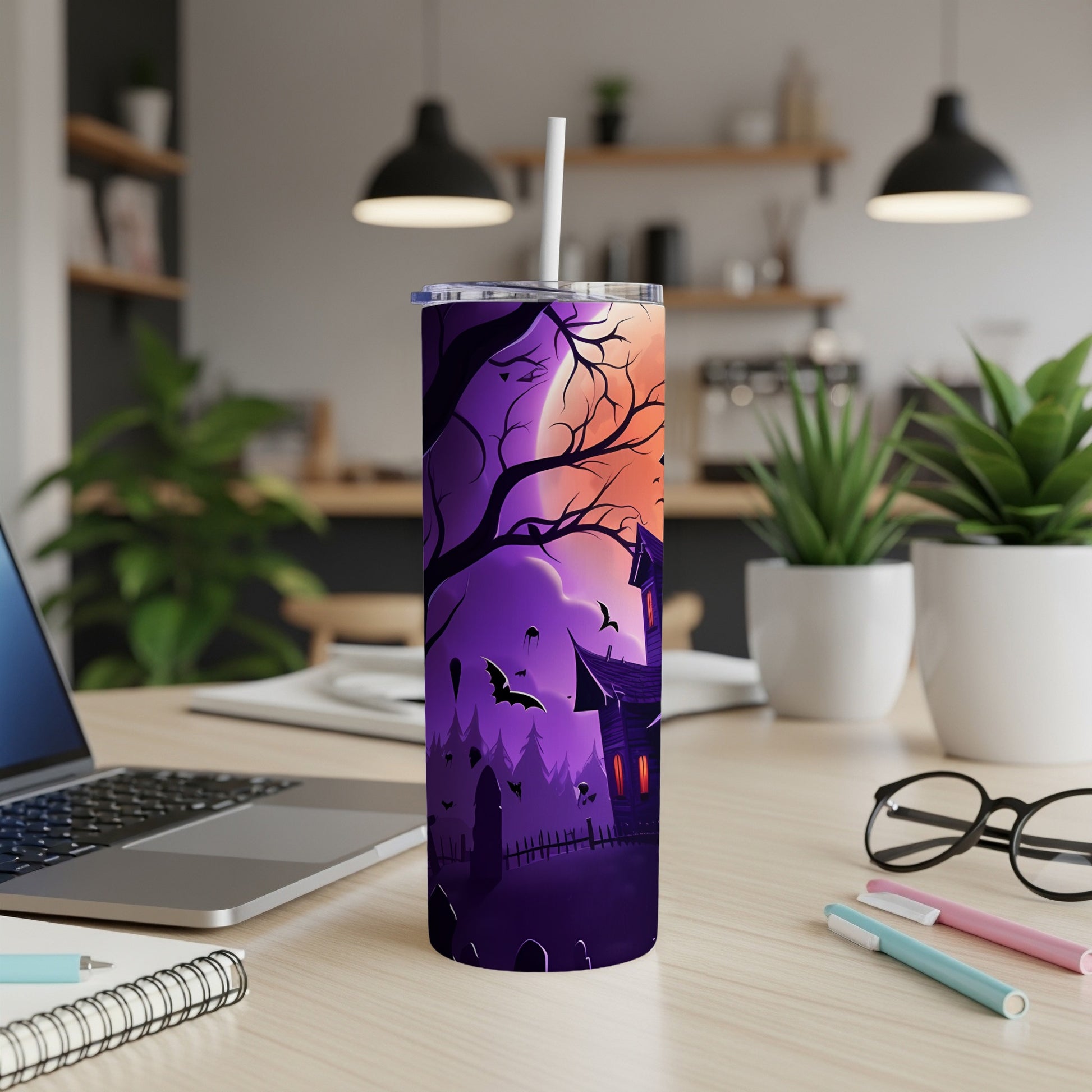 Purple tumbler with Halloween haunted house, bats, and graveyard design.