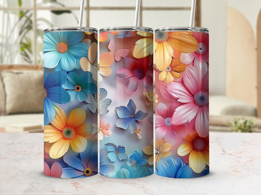 Three tall tumblers with floral designs in blue, pink, and orange.