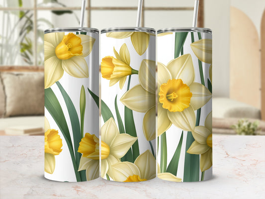 Yellow daffodils and green leaves on three tall tumblers.