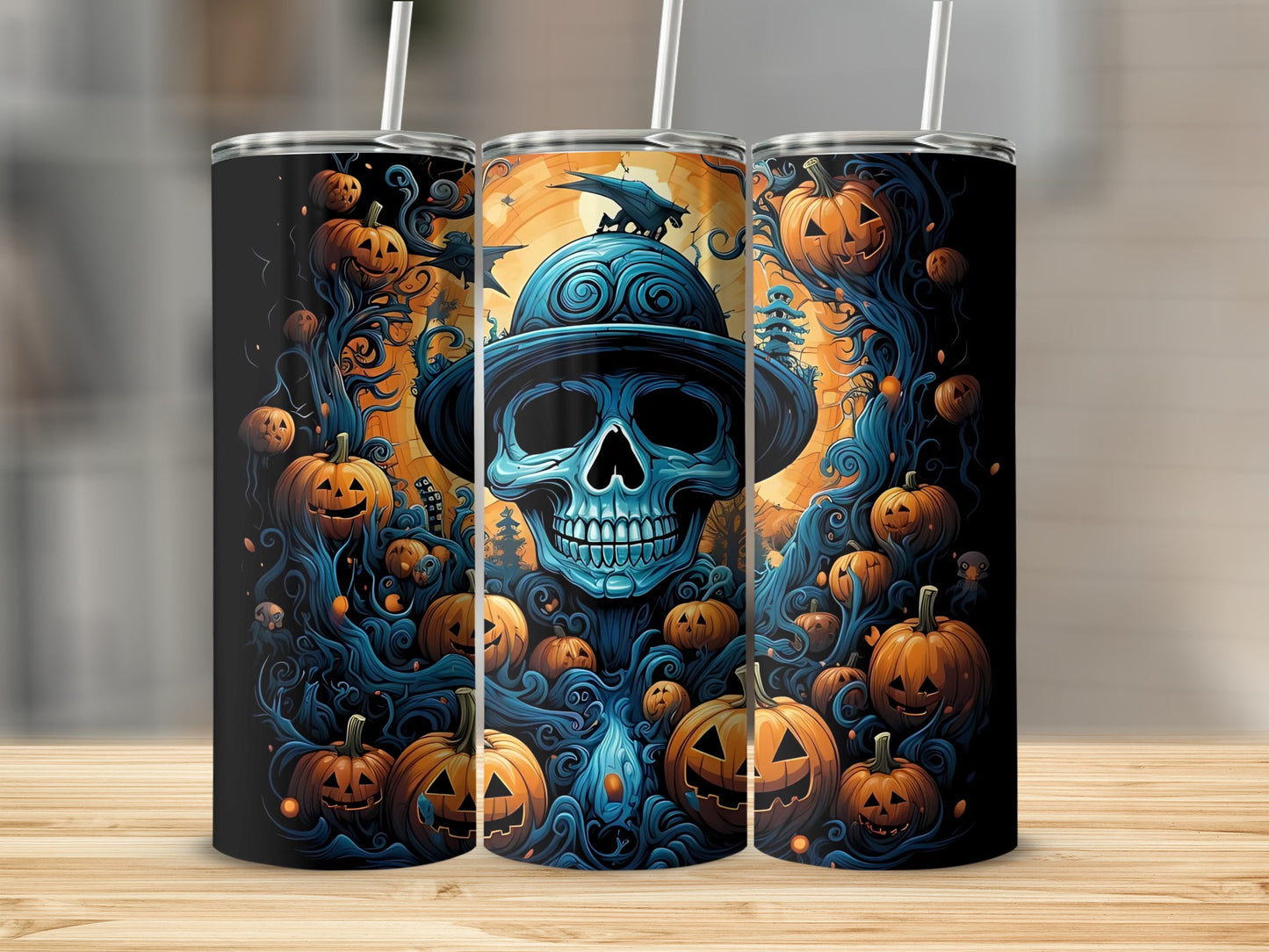 Three tumblers with a spooky Halloween design featuring a blue skull and pumpkins.