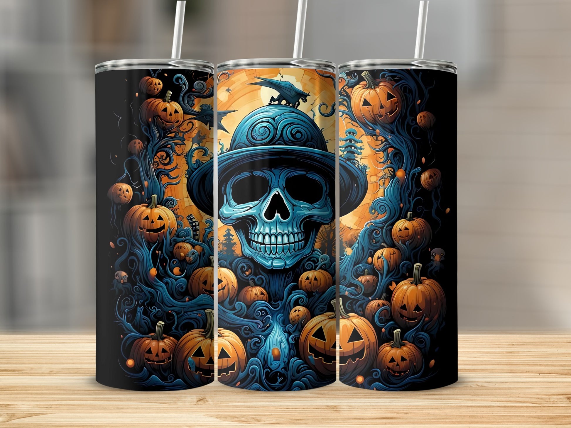 Three tumblers with a spooky Halloween design featuring a blue skull and pumpkins.