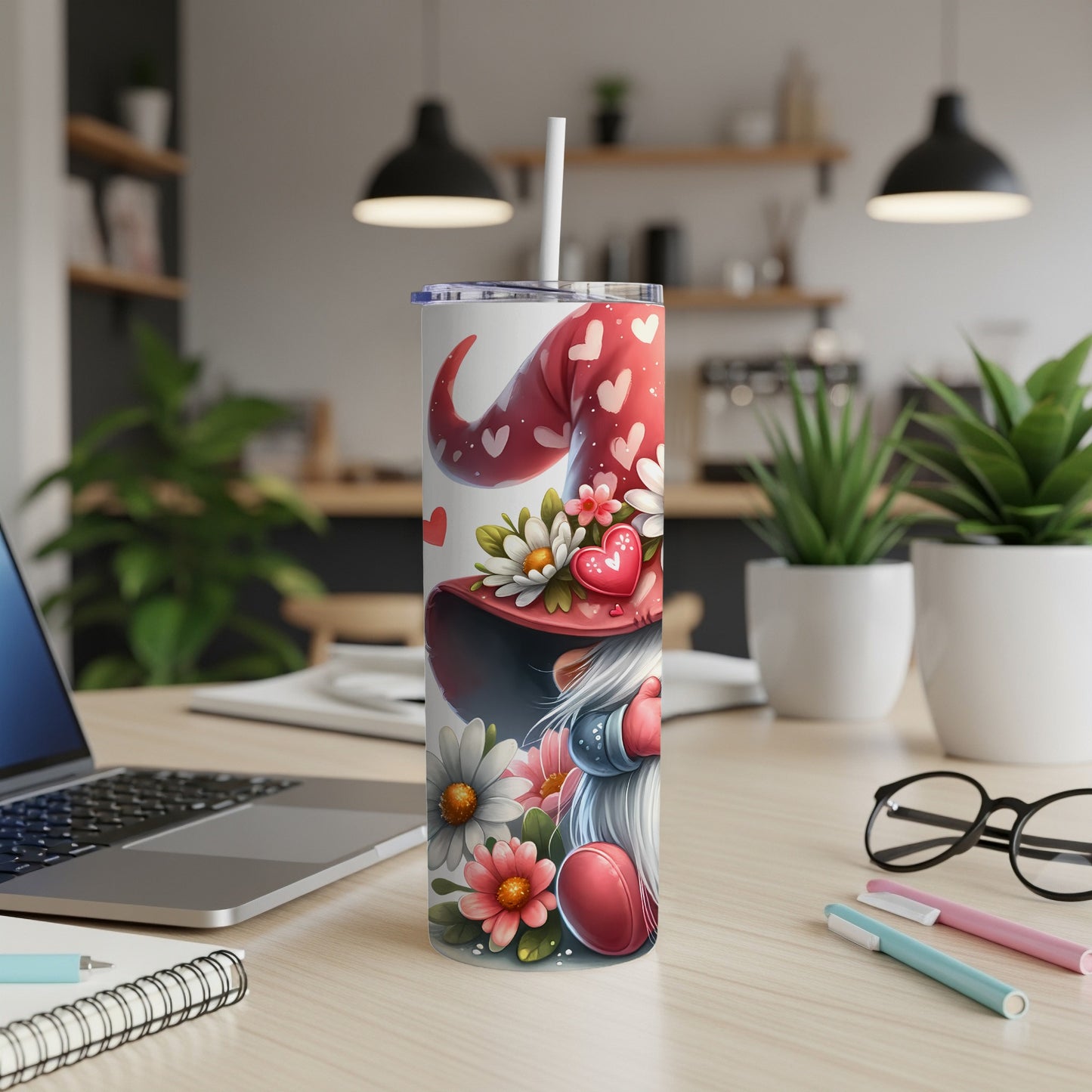 Valentine's Day gnome tumbler with hearts and flowers on a desk.