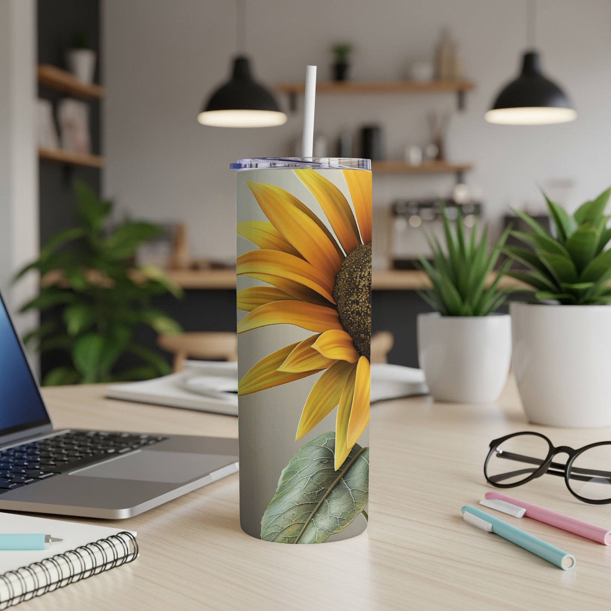 Sunflower design on a white stainless steel tumbler with a straw.
