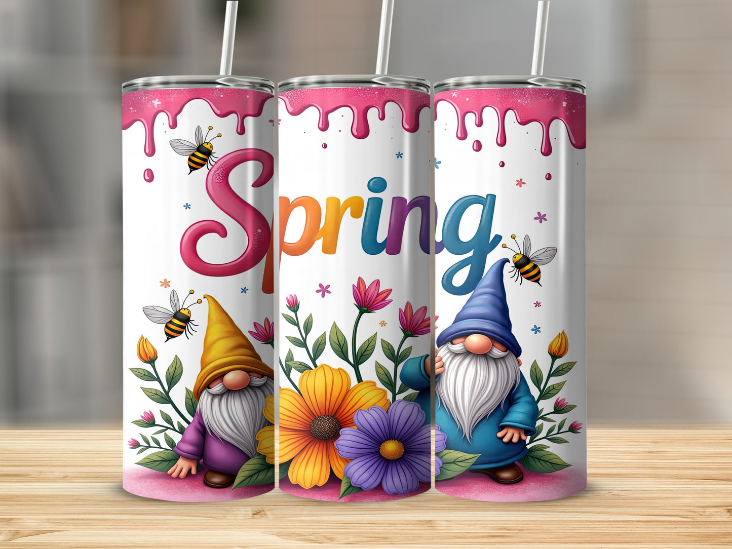 Three tumblers with spring gnomes, flowers, and bees on a wooden surface.