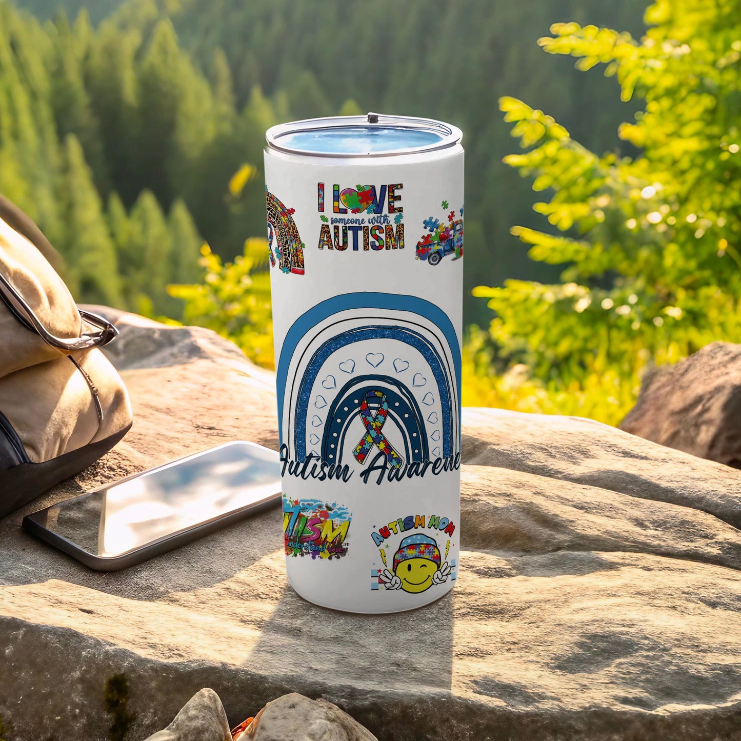 Autism awareness tumbler with rainbow and puzzle pieces.