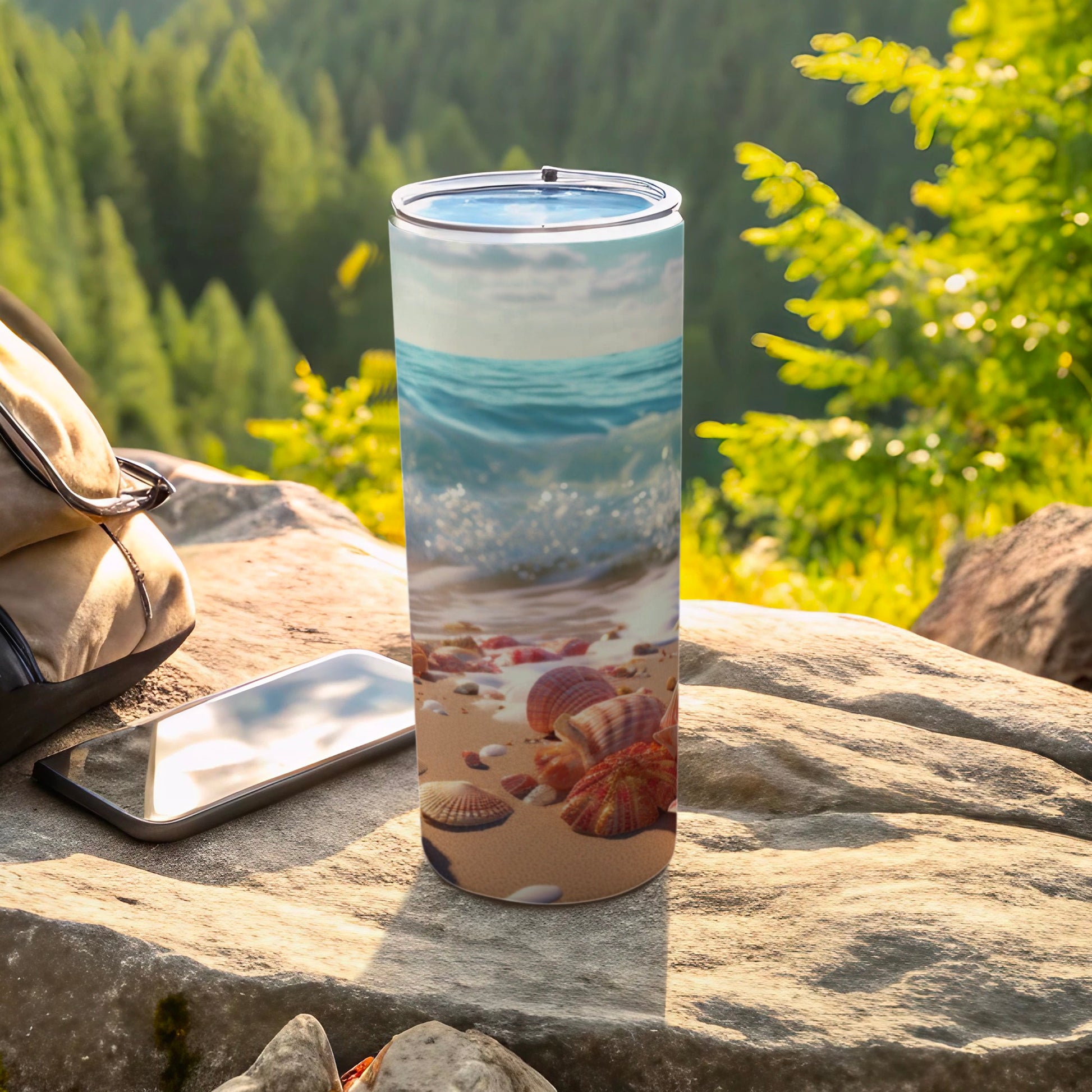 Beach scene tumbler with seashells and ocean waves.