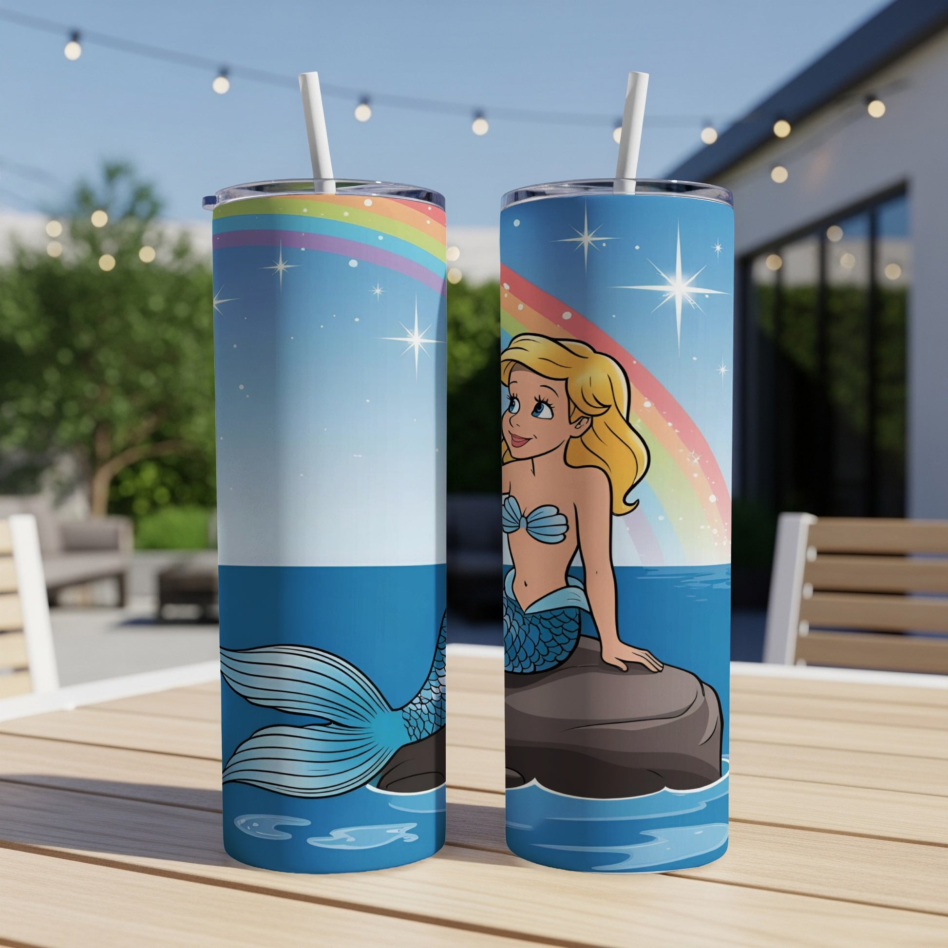 Two tumblers with a cartoon mermaid on a rock with a rainbow.