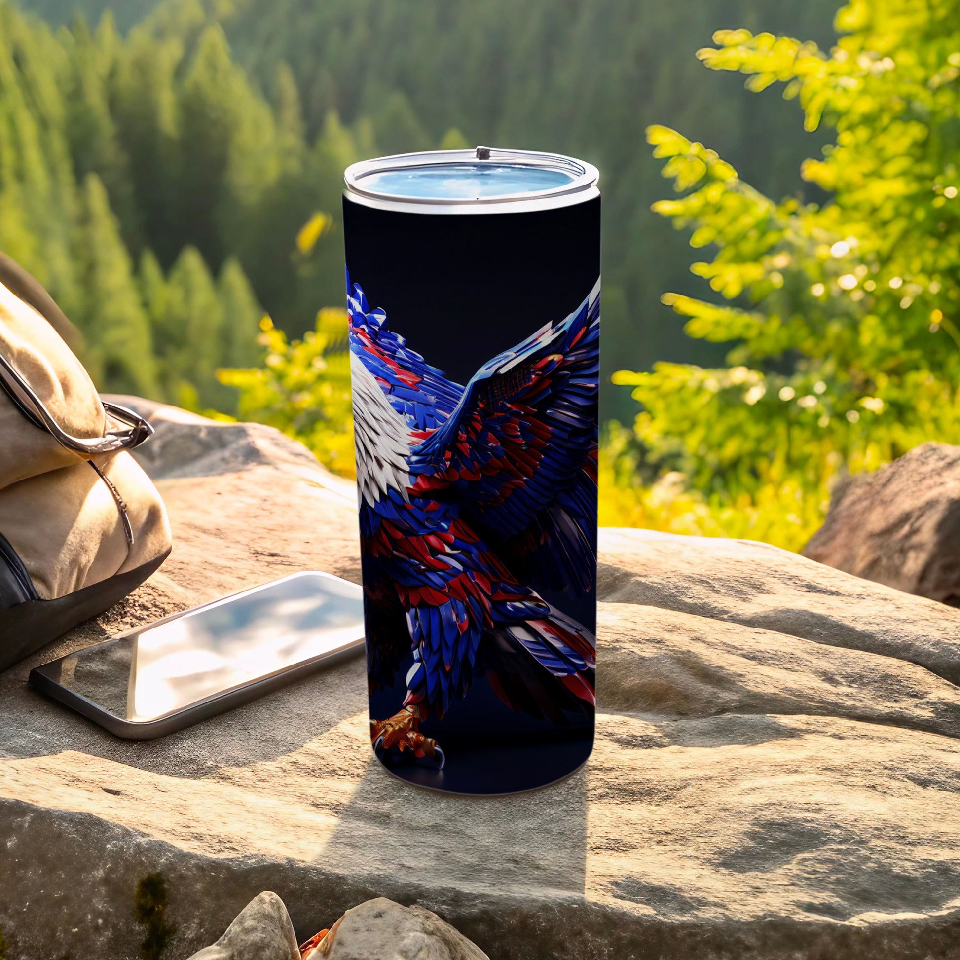 Patriotic eagle tumbler with dark background, phone, and backpack.